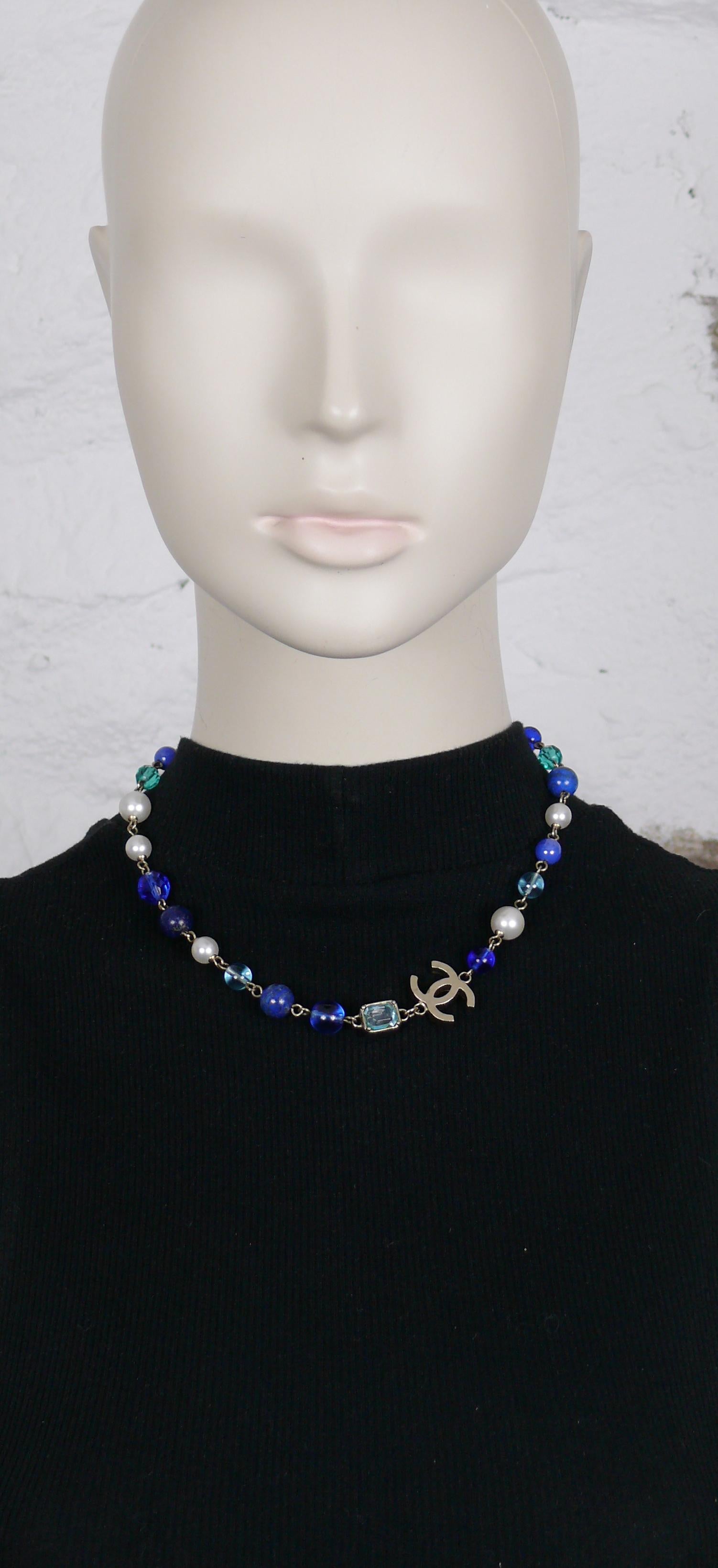 CHANEL short necklace made of turquoise blue facetted glass beads, faux pearls, blue glass beads, lapis lazuli pearls, aqua blue crystals and textured CC logo.

Please note that, to our opinion, the color of the hardware is very pale gold tone, but