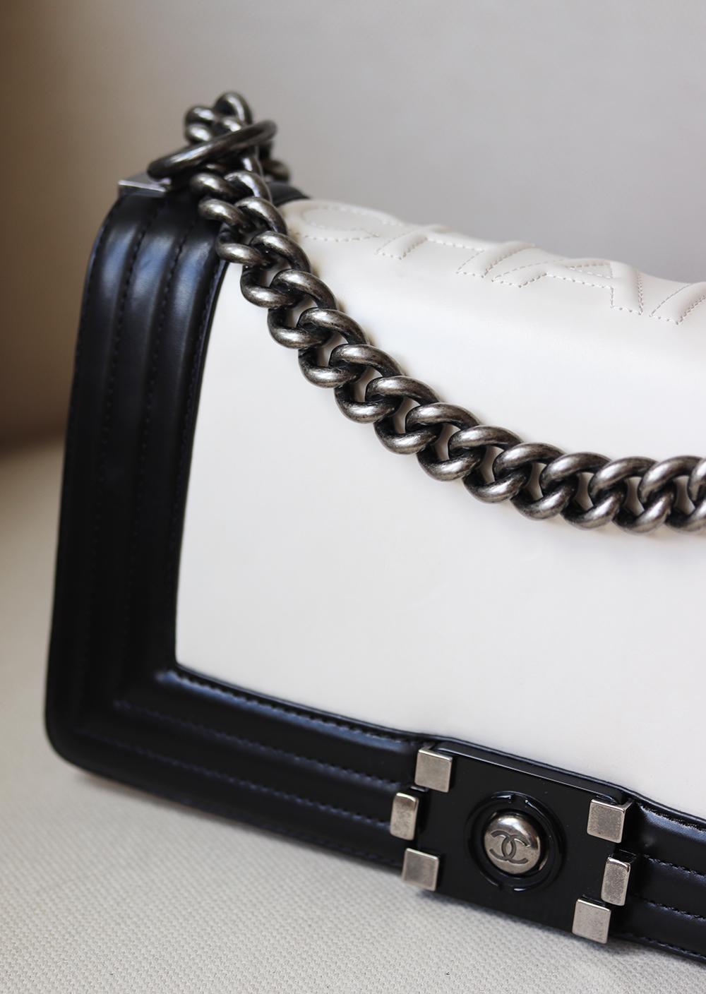 Chanel Glazed Calfskin Leather Boy Flap Bag has been hand-finished by skilled artisans in the label's workshop.
Boasting smooth black and ivory calfskin-leather exterior, this design is accented with silver-toned and black calfskin-leather chain