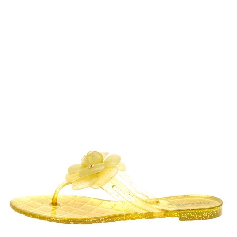 Crafted beautifully with yellow jelly, these flat sandals designed in thong style are adorned with the signature Camellia flower on the front. It is further embellished with petite CC logos that sit atop the camellia flower. The comfortable fit and