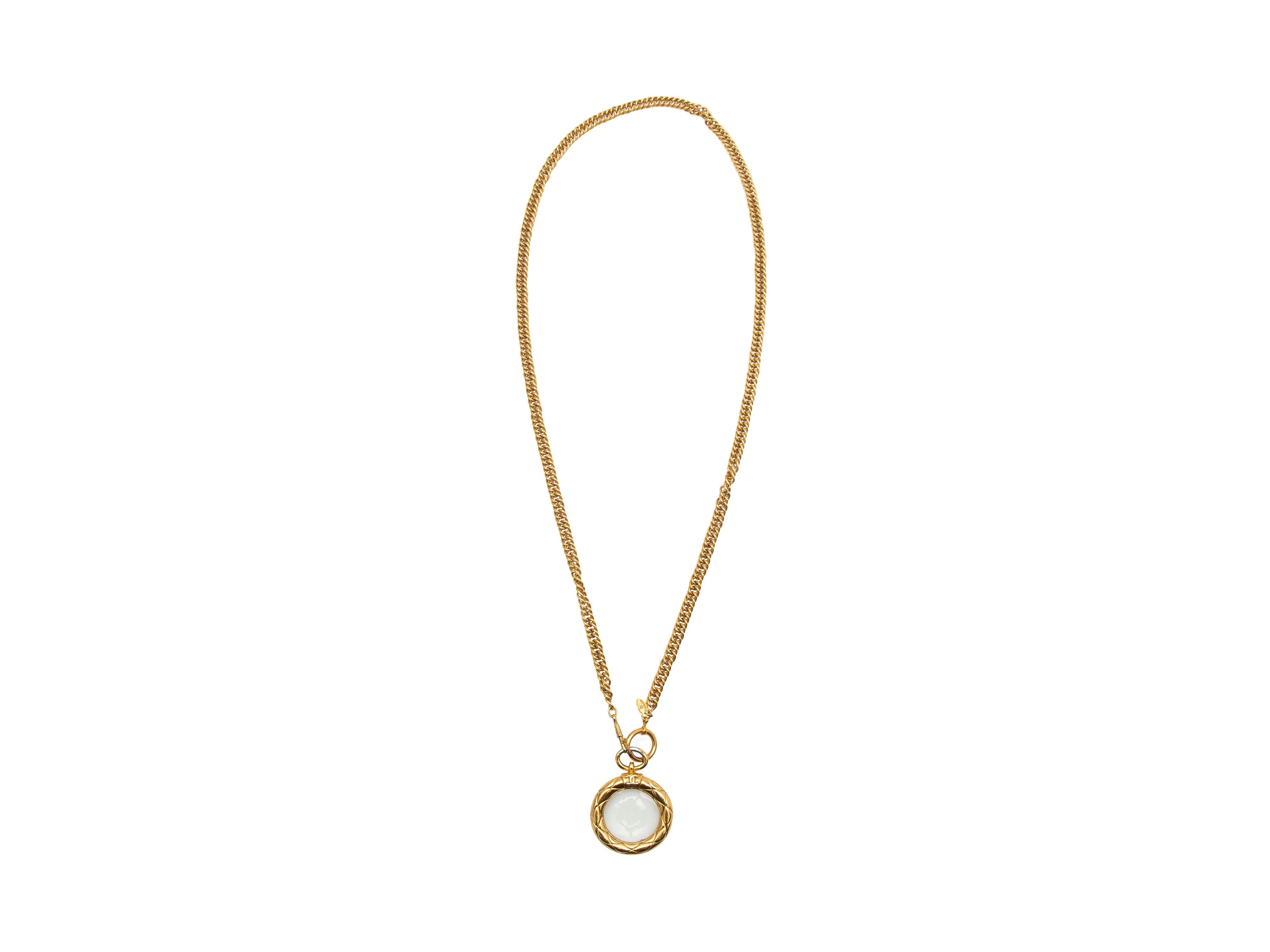 Product details: Vintage gold magnifying glass necklace by Chanel. Circa 1980s. Clasp closure at end. 20.5
