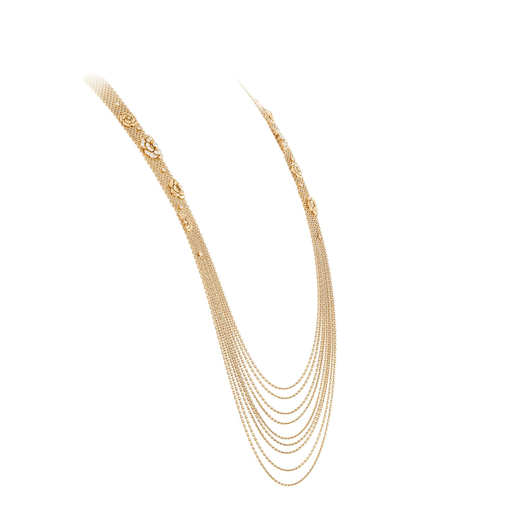 Authentic Chanel necklace crafted in 18k yellow gold.  The long flapper style necklace is comprised of several fine chains that are connected at the top and hang loosely at the bottom of the necklace creating a stunning fringed effect.  Chanel's