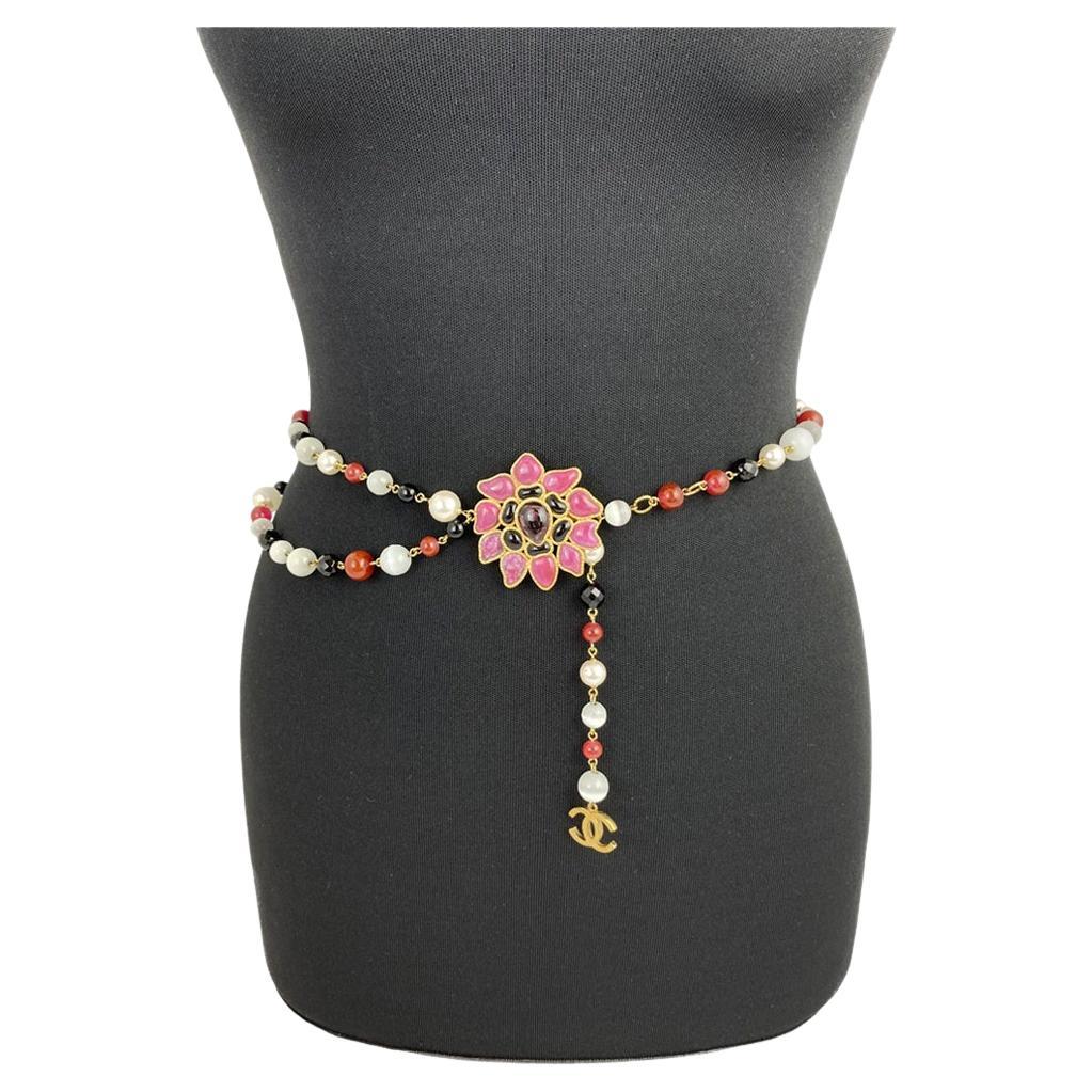 Chanel Vintage 2007 Maison Gripoix Camellia and Multi Colored Pearl Chain Belt. Features a hook closure of the back of the camellia flower and a dangling CC logo charm. Can be adjusted in size from S to L.

