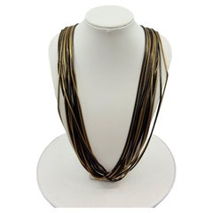 Chanel - Sautoir multibrins en chaîne serpent d'or et de noir métallisé