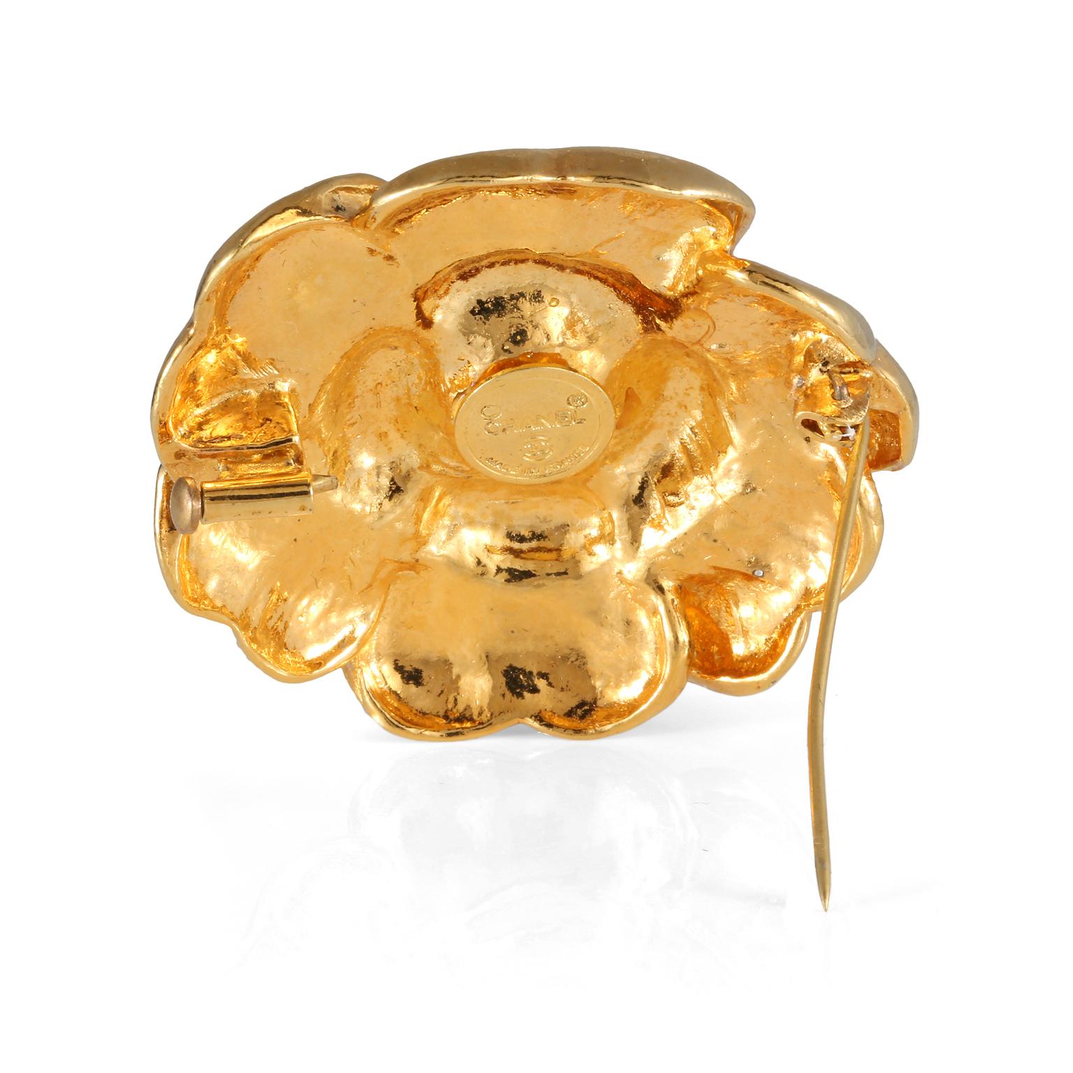 This authentic Chanel Gold Camellia Flower Pin is in exceptionally good vintage condition from the late 1970’s.  The iconic gold tone camellia flower is the perfect adornment for any jacket, top or wrap.   Made in France. Pouch or box included.

 
