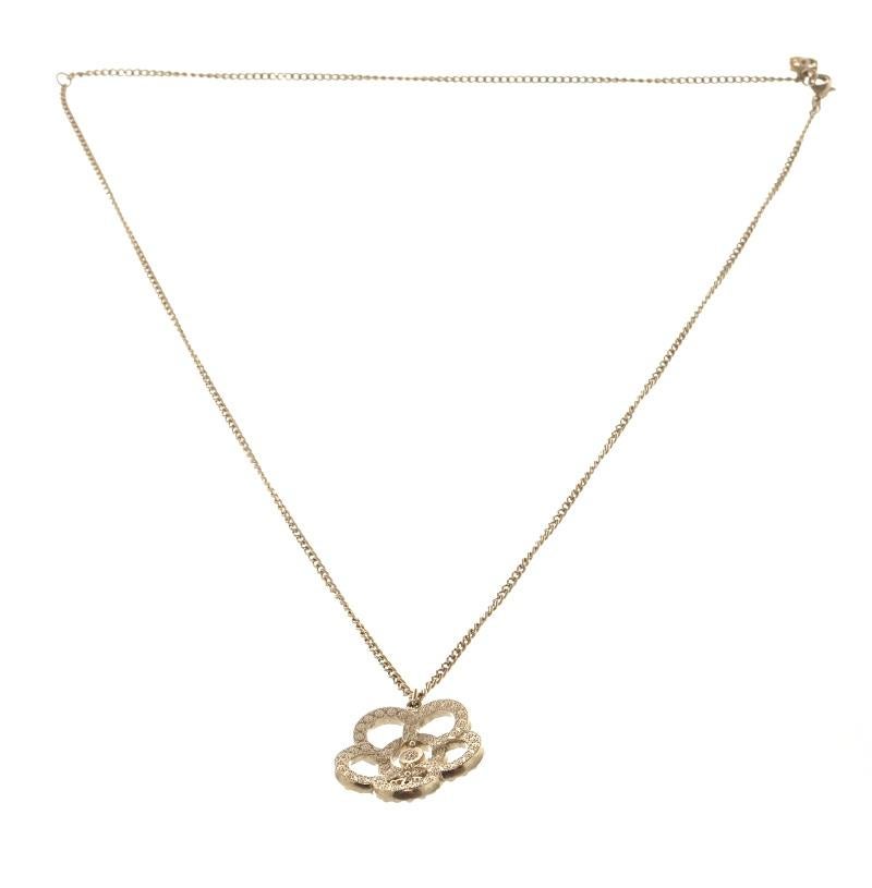 Chanel Gold Camellia Pearl Necklace with CC logo pendant with faux pearls and gold tone metal hardware. 

770084MSC