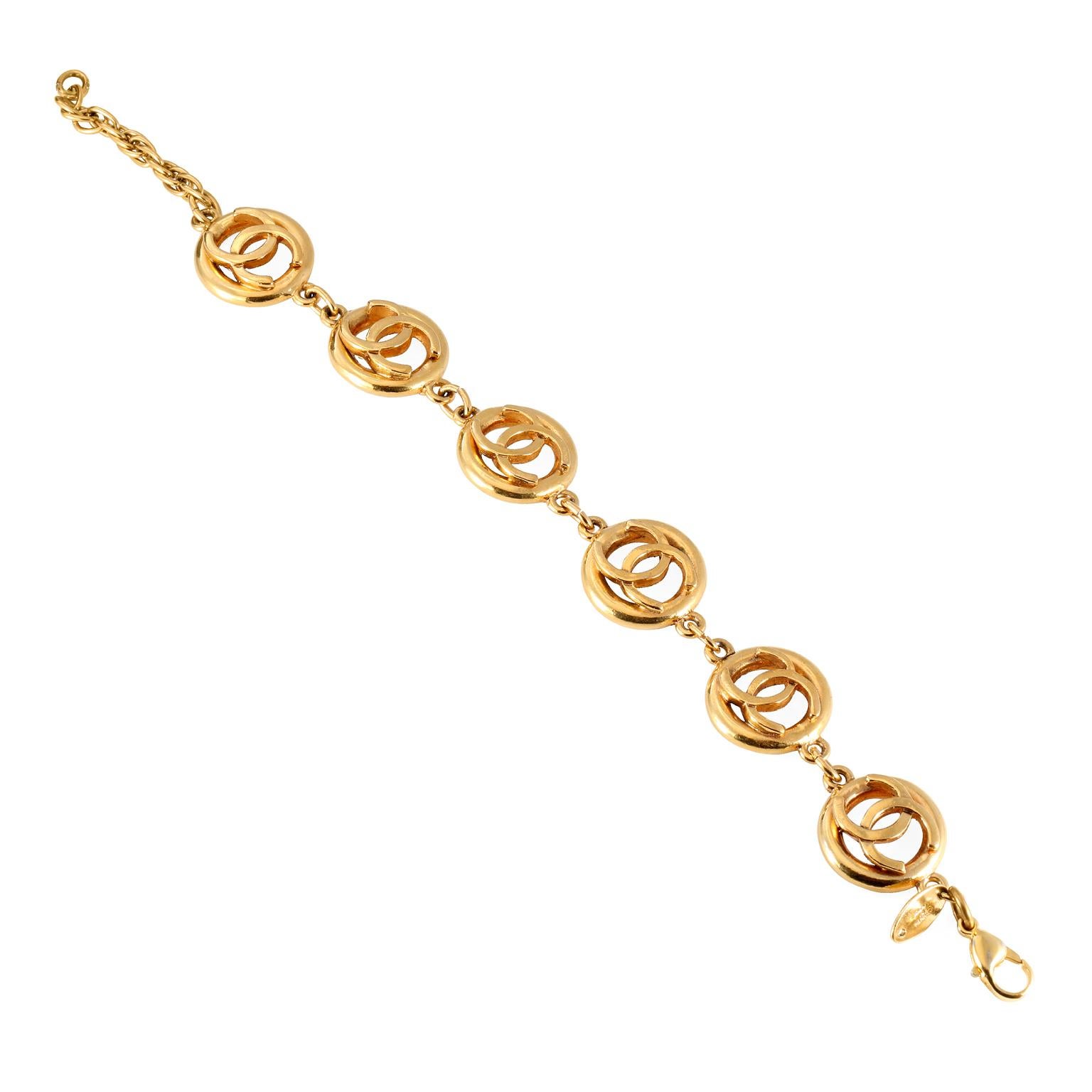 This authentic Chanel Gold CC Bracelet is in exceptionally good condition from the 1983 collection.  Open gold tone circles with raised interlocking CC on each.  Made in France.  Approximately 9.5 inches, adjustable.    Pouch or box included. 
