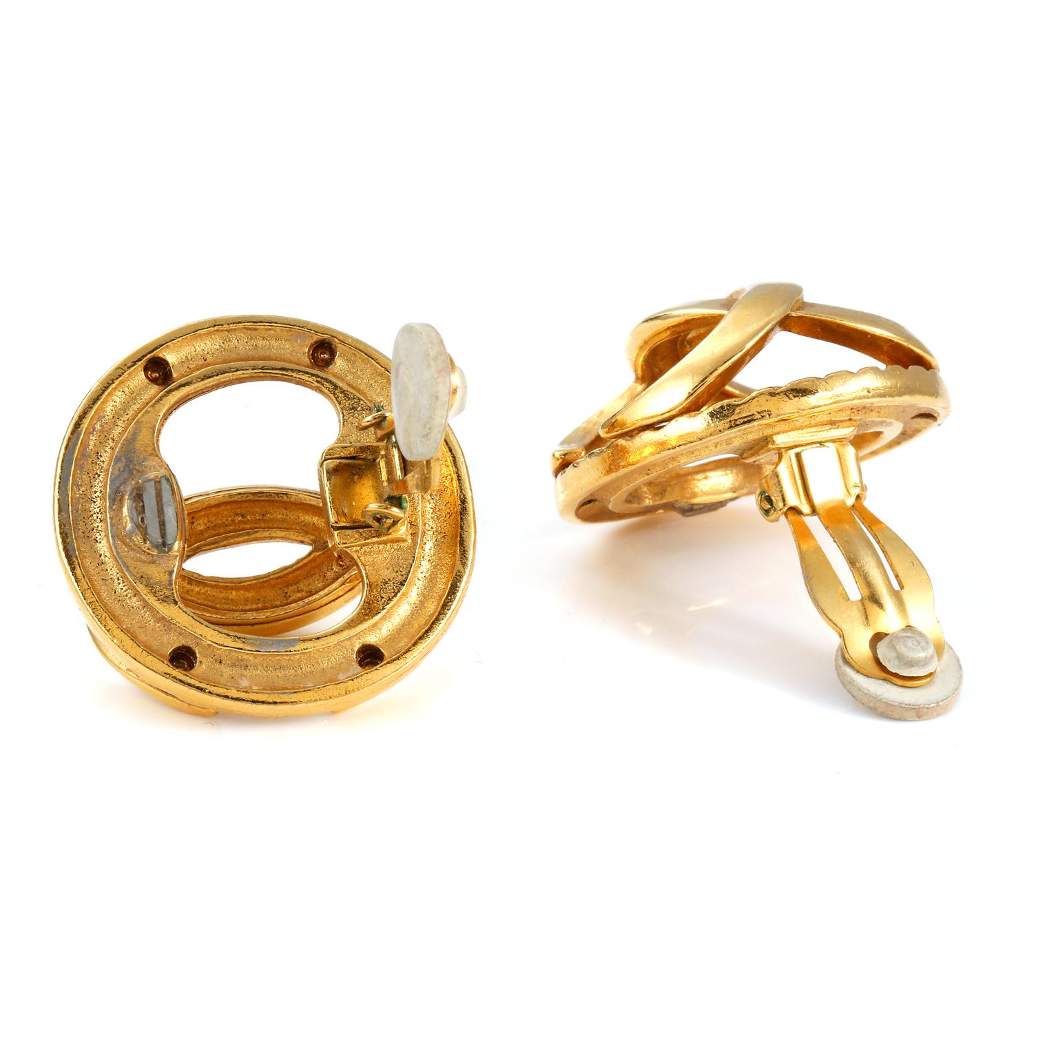 These authentic Chanel Gold CC Cage earrings are in very good vintage condition.  Gold interlocking CC in a convex formation creates a three-dimensional caged earring.  Clip on closure. Pouch or box included. 

