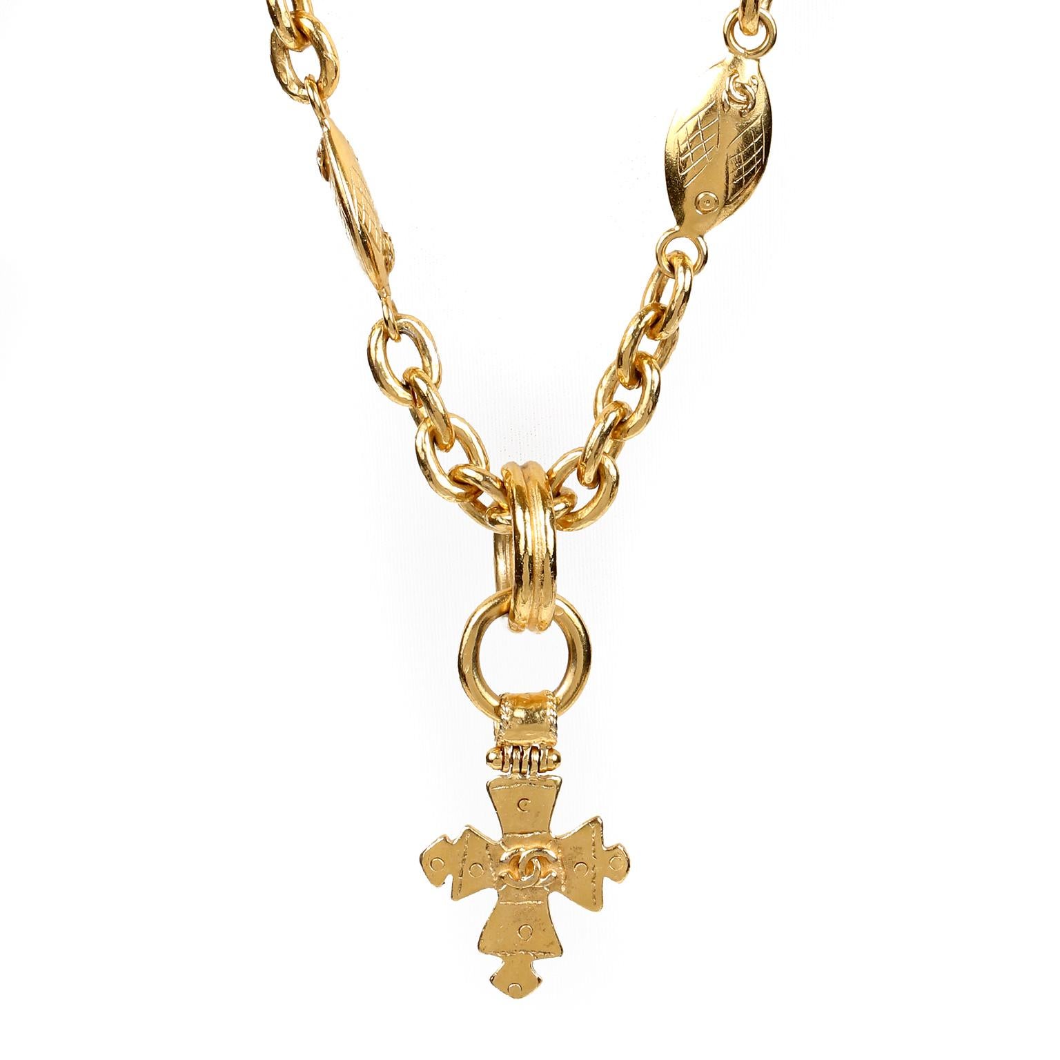 This authentic Chanel Gold CC Cross Necklace is in excellent vintage condition.  Interlocking CC adorned gold tone cross dangles from a long ornate chain.  Chain measures approximately 36 inches, pendant 2 inches.  Pouch or box included.

