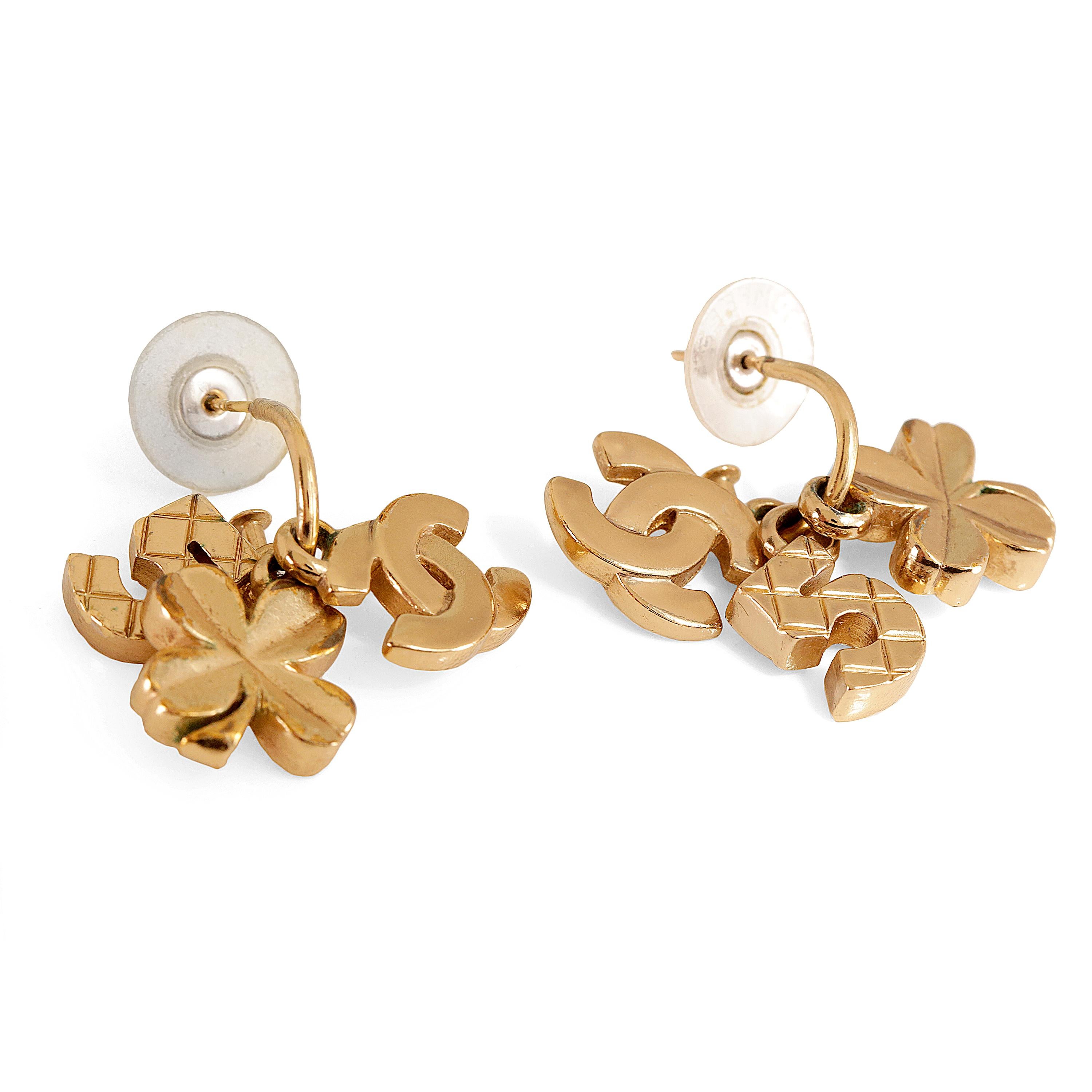 These authentic Chanel Gold CC Lucky Clover Runway Earrings are in excellent condition.  An interlocking CC charm, quilted gold number 5 and a four-leaf clover dangle from a slim gold hoop.  Pierced post style.  

