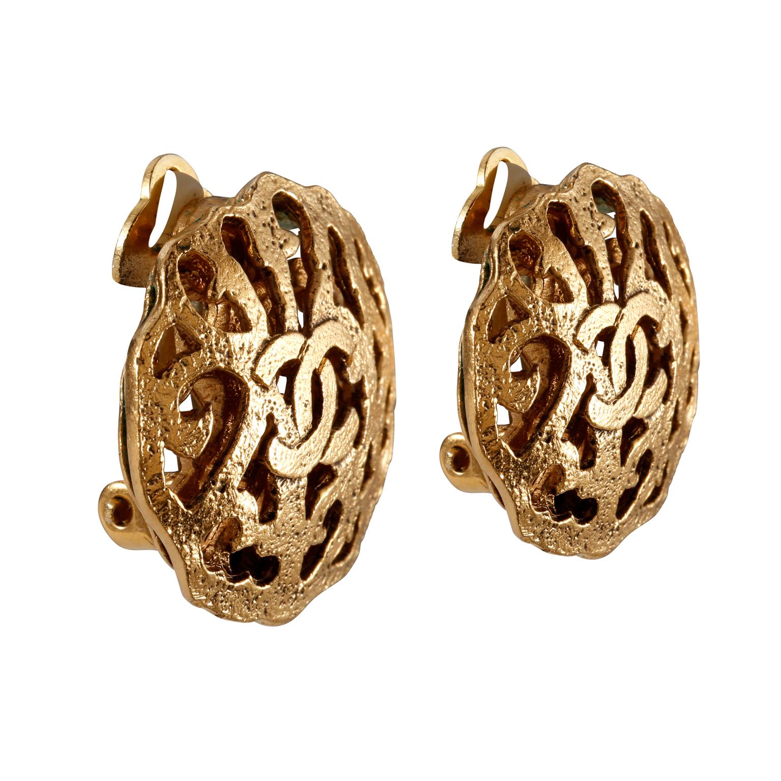 These authentic Chanel Gold CC Cut Out Button Earrings are in excellent condition from the mid 1980’s.  Gold tone round clip on earrings with ornate cut out design and interlocking CC.  Made in France. 
