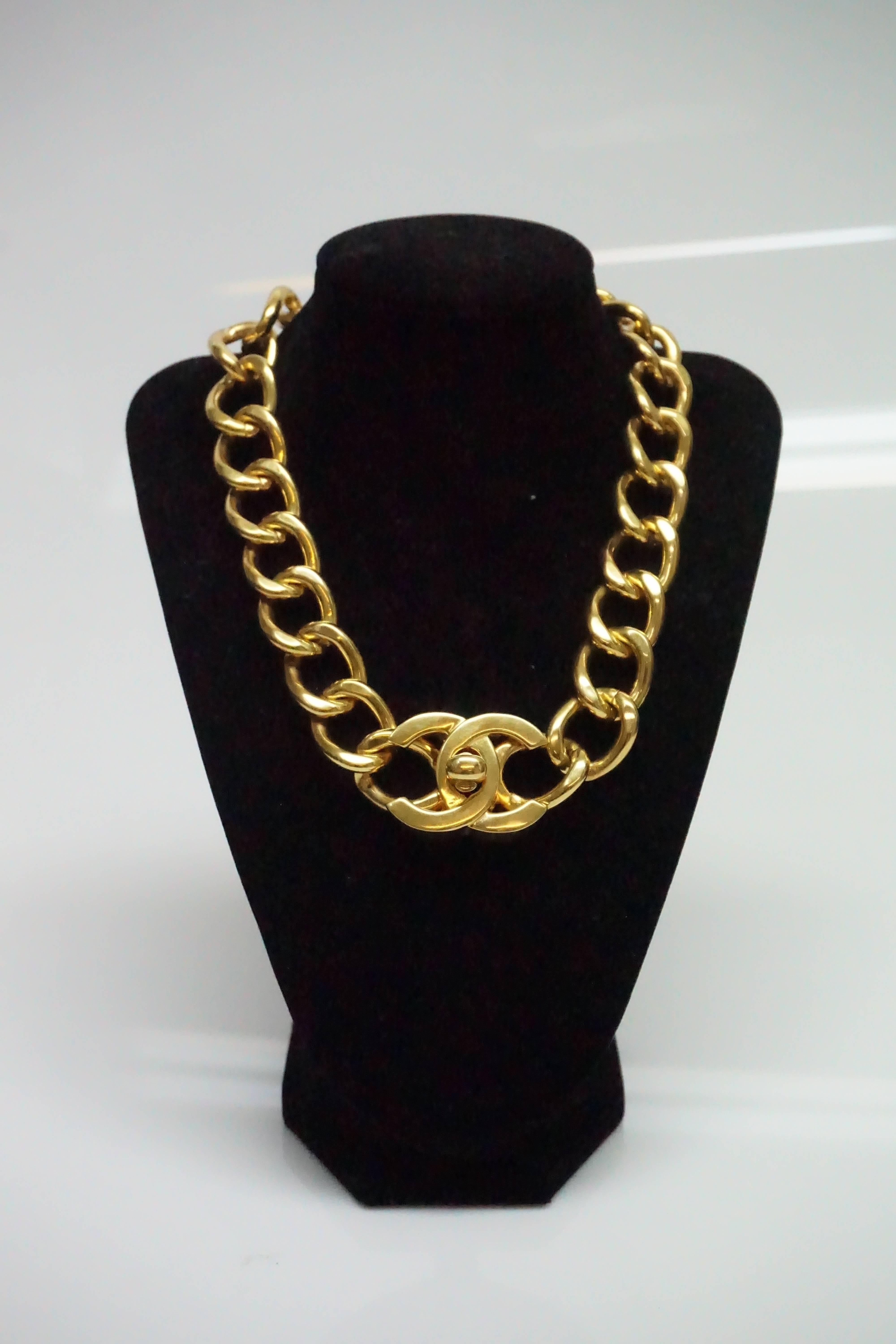 Chanel Gold Chain Link Necklace with Turnkey CC Closure- 95A.  This classic Chanel piece is in excellent condition. There are barely any scratches on it, just a few on the chains and around the CC logo. The necklace has an opening where the CC logo