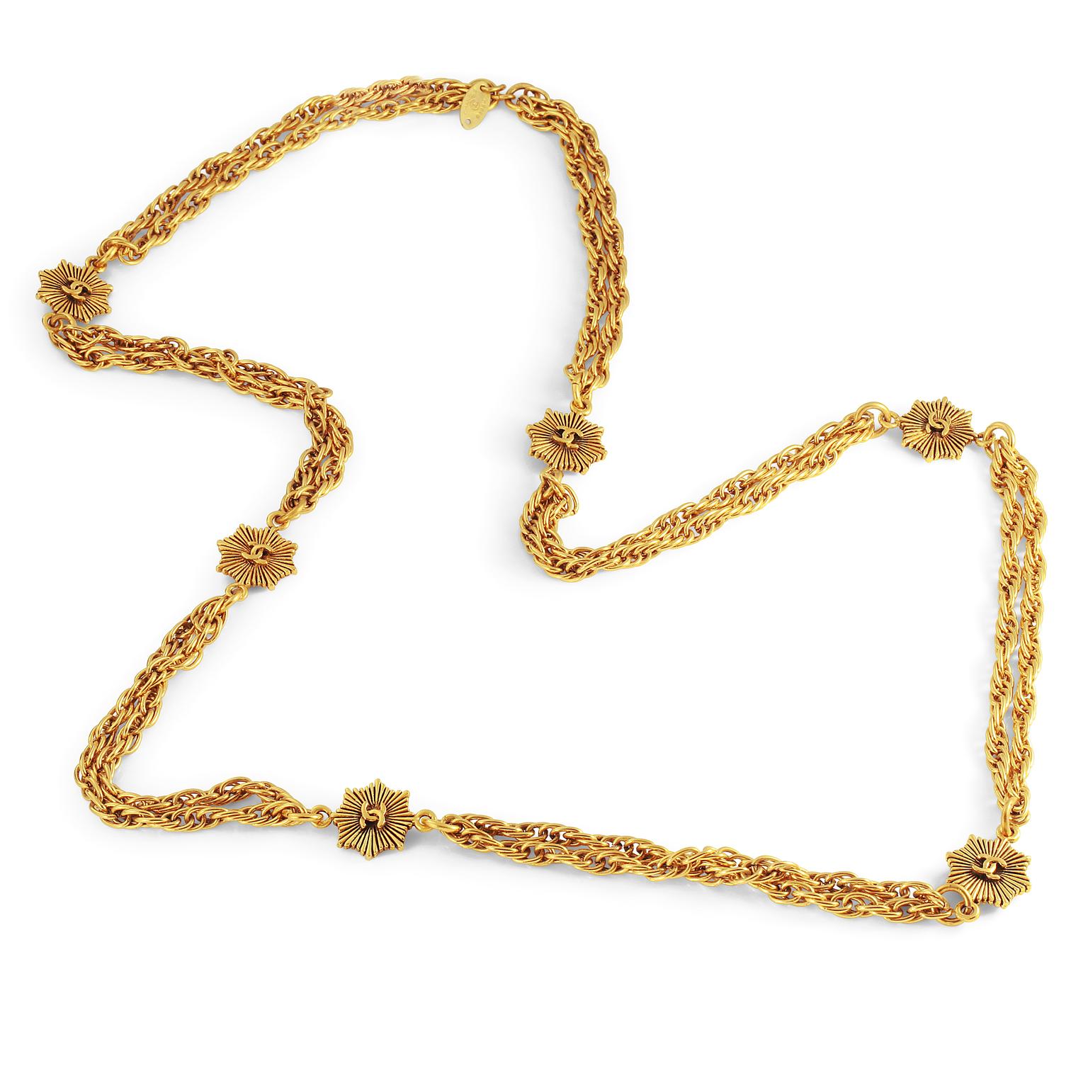 This authentic Chanel Gold Chain with CC Pendants is in excellent vintage condition from the 1984 collection.  Double stranded gold linked long chain has six CC starburst pendants stationed throughout.   34” approximately. Made in France.  Pouch or