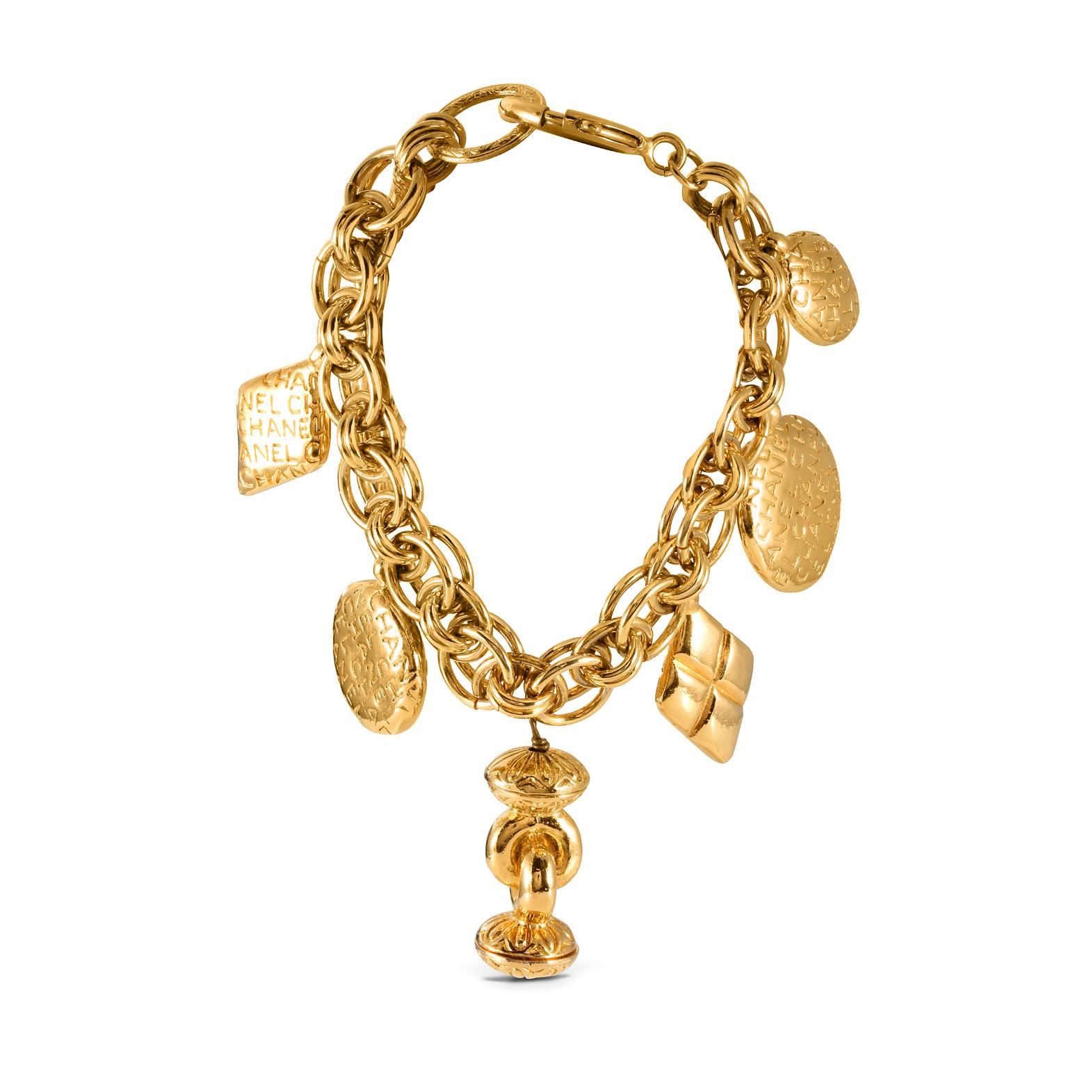 This authentic Chanel Gold Charm Bracelet is in excellent vintage condition.  CHANEL engraved gold tone charms dangle from a gold tone link bracelet.    Pouch or box included.
ACO 11032


