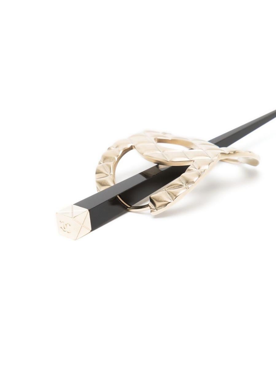Keep your hair loose and undone for an effortlessly chic and thrown-together look with this pre-owned Chanel barrette.  As seen on the Chanel AW16 runway, the champagne CC barrette with quilted detailing is secured into your hair using a hair stick.