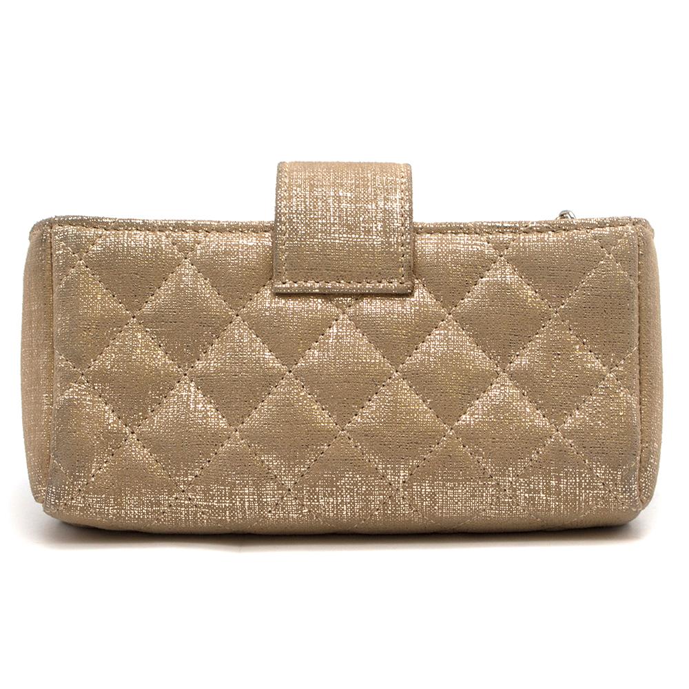 Chanel Gold Coated Coin Purse/Phone Holder 

-Gold, foiled-effect coated fabric
-Gold-tone metal hardware 
- Magnetic fastening top strap
- Two open compartments, one zip-fastening compartment 
-Beige micro-fibre lining 
-Comes with the authenticity