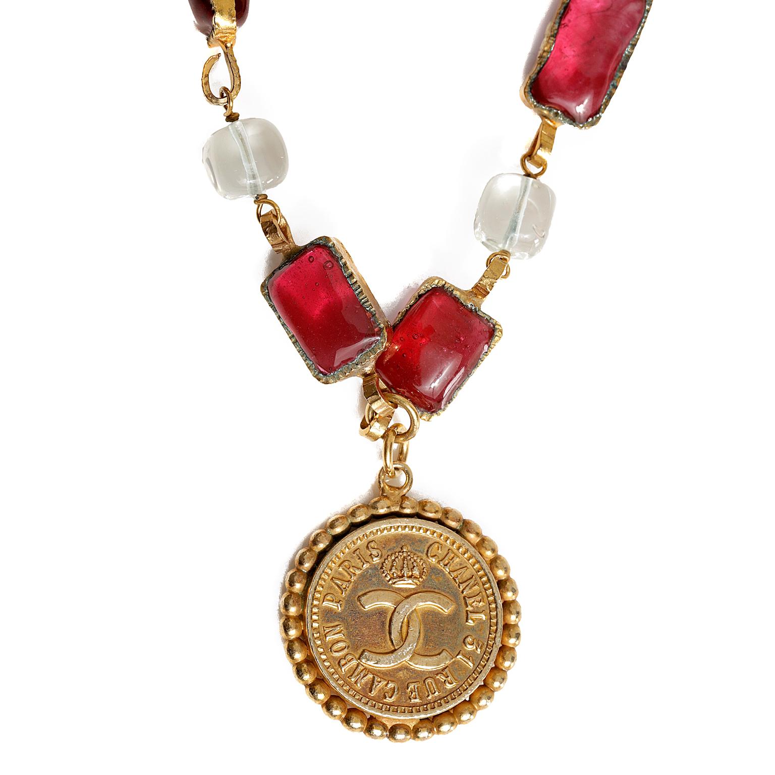 Chanel Gold Coco Chanel Medallion Necklace- Excellent Condition
Long gold rope chain stations with red and clear Gripoix poured glass gems.  Gold interlocking CC Rue Cambon medallion has Coco in silhouette on one side.  Approximately thirty-eight