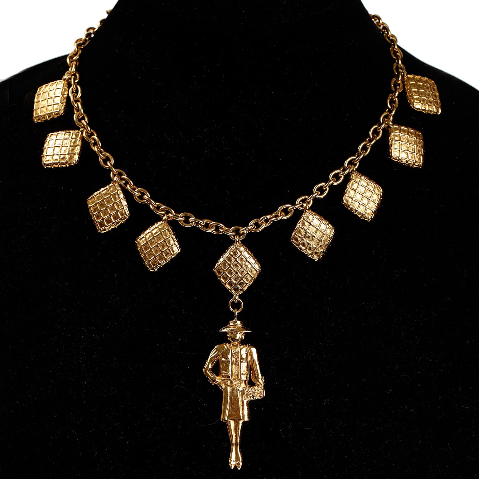 Chanel Gold Coco Pendant Necklace- excellent condition
Choker length gold chain with quilted charms.  Classically clad gold Coco charm dangles from the center.  Length fourteen inches. 

