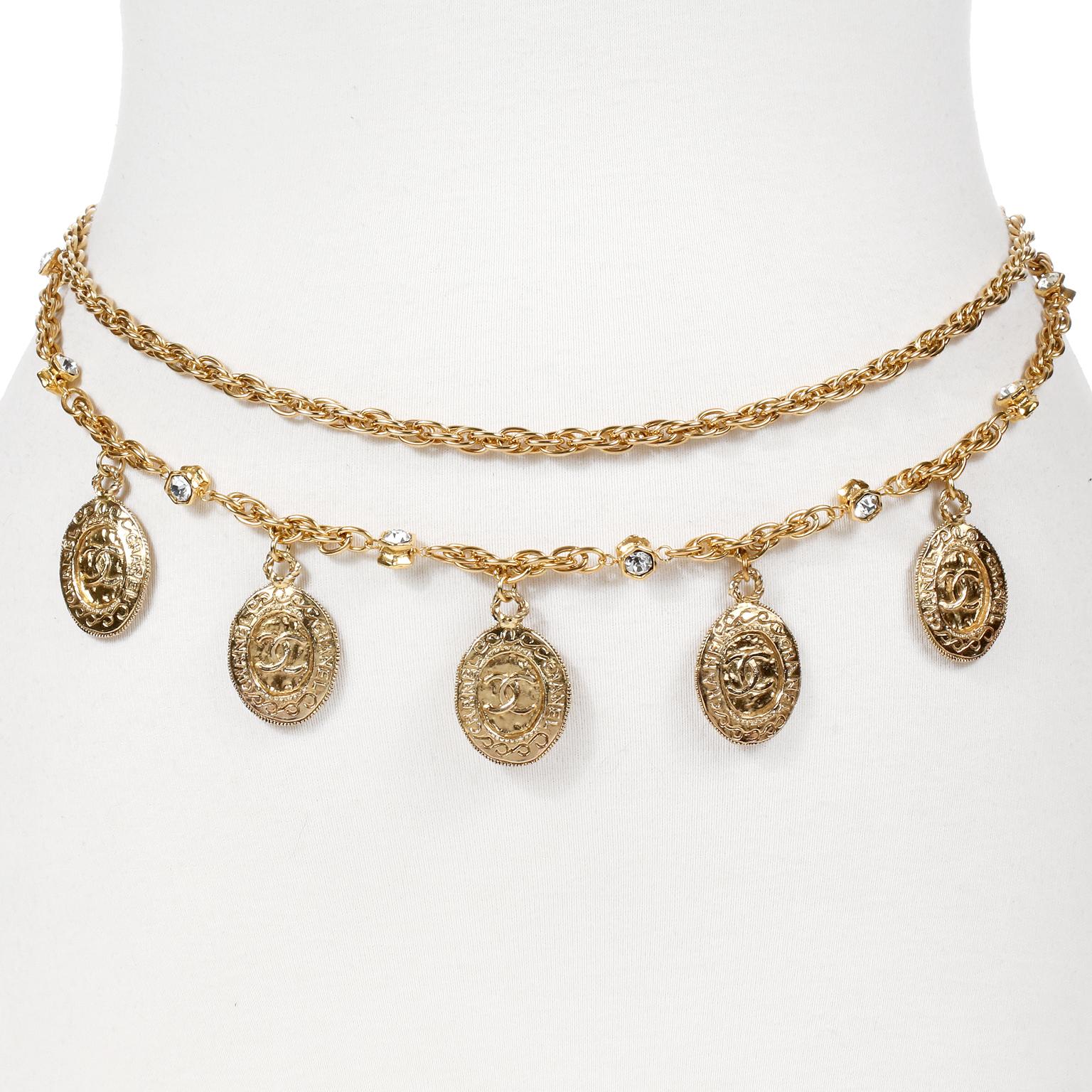 This authentic Chanel Gold Coin and Rock Crystal Necklace Belt is in excellent vintage condition.  Worn in a double layer as a necklace or belt, this classic piece is a must have for any collection.  Five CHANEL engraved CC coins dangle from a gold