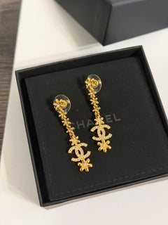 Boucles d'oreilles pendantes CHANEL « CC » en cristal floral doré