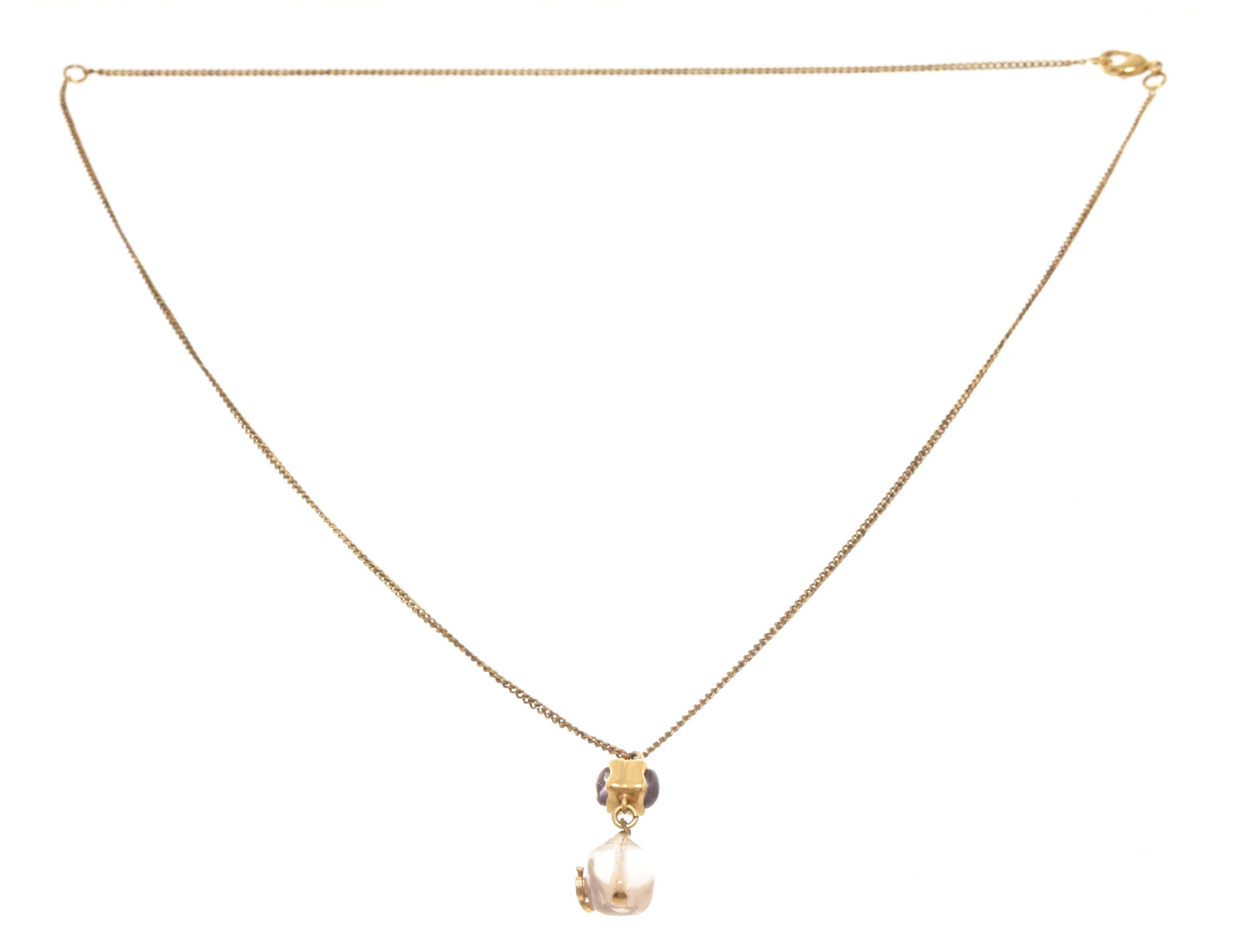 Chanel gold gem long necklace with gold-tone chain, lobster claw closure, and a clear pink gem pendant with a CC logo dangling. 


770036MSC