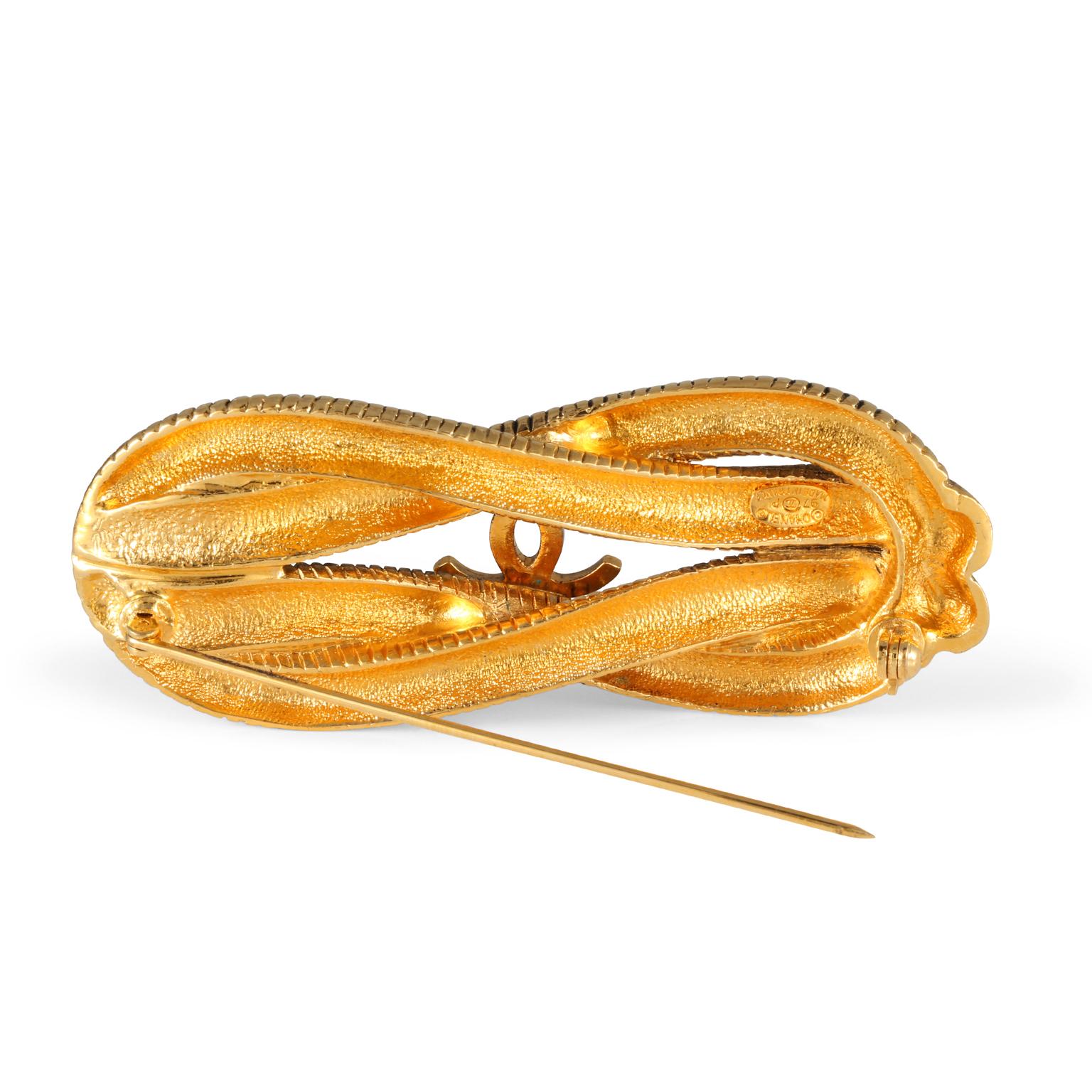 This authentic Chanel Gold Knotted Snake Chain Brooch is in excellent condition from the Spring 1997 collection.  Gold tone knotted snake chain features an interlocking CC in the center.  Made in France.  Pouch or box included.

 

