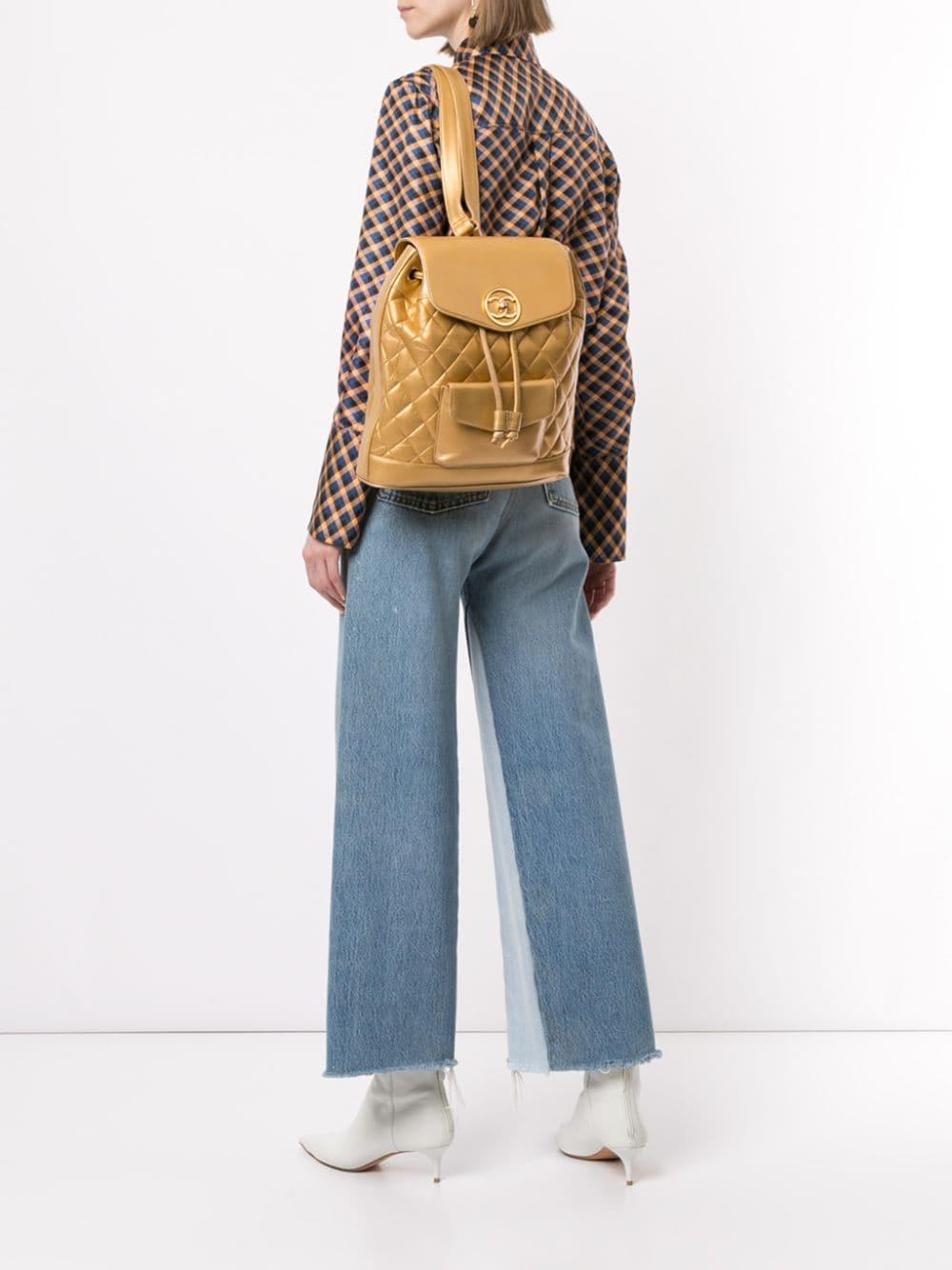 Circa 1991-1994. Vintage Chanel quilted leather backpack features gold tone hardware, dual leather and interwoven chain straps, front patch pocket, front flap with a CC turn lock closure, drawstring opening, and an unlined interior.

Made in Italy