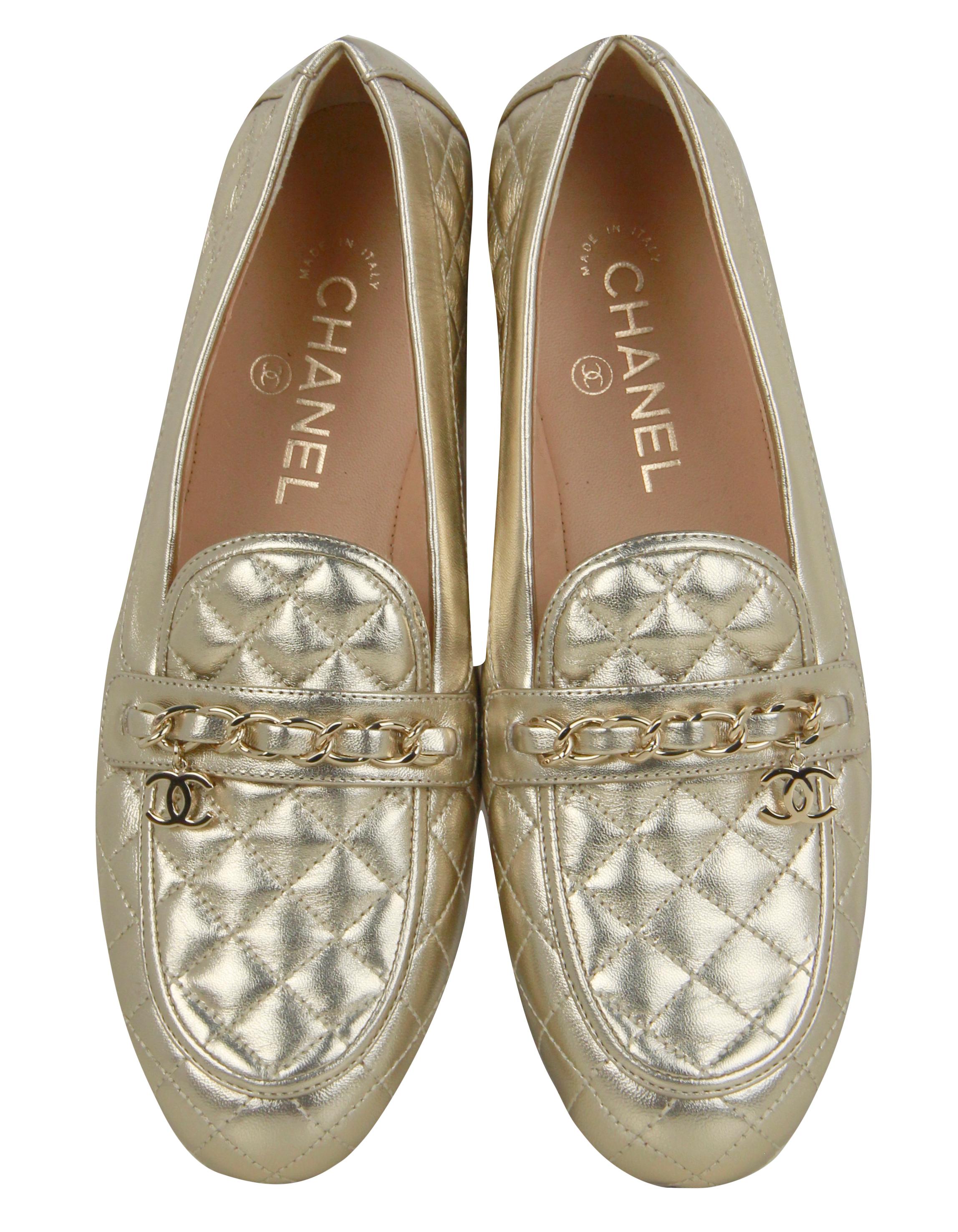 Chanel Gold Lambskin Quilted Chain CC Loafers sz 39C

Made In: Italy
Color: Gold
Materials: Leather with metal
Closure/Opening: Slide on
Overall Condition: New with light peeling to outer right heel (see photo) 
Includes: Chanel dustbag and