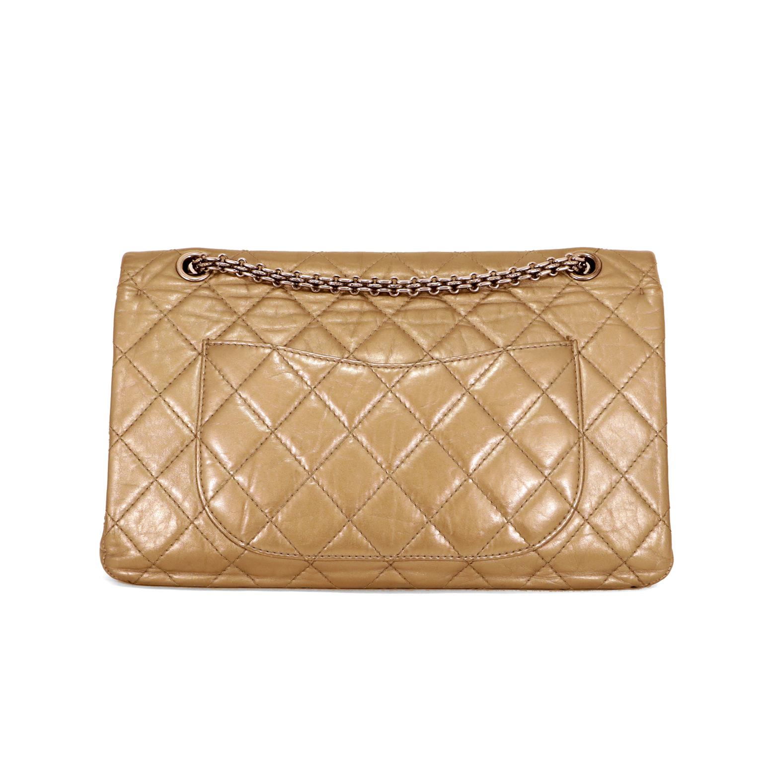 This authentic Chanel Gold Lambskin Reissue Flap Bag is in excellent plus condition.  Perfect for day or evening, the 227 size is roomy without being oversized.  
Metallic gold lambskin is intentionally distressed and quilted in signature Chanel