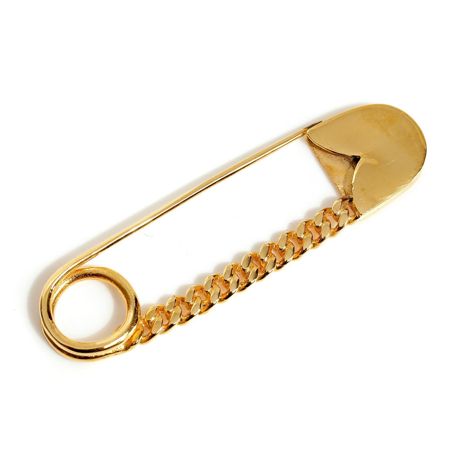 Chanel Gold CC Large Safety Pin 
Excellent condition.  Approximately three inches.  Black interlocking CC gold link detail.  
