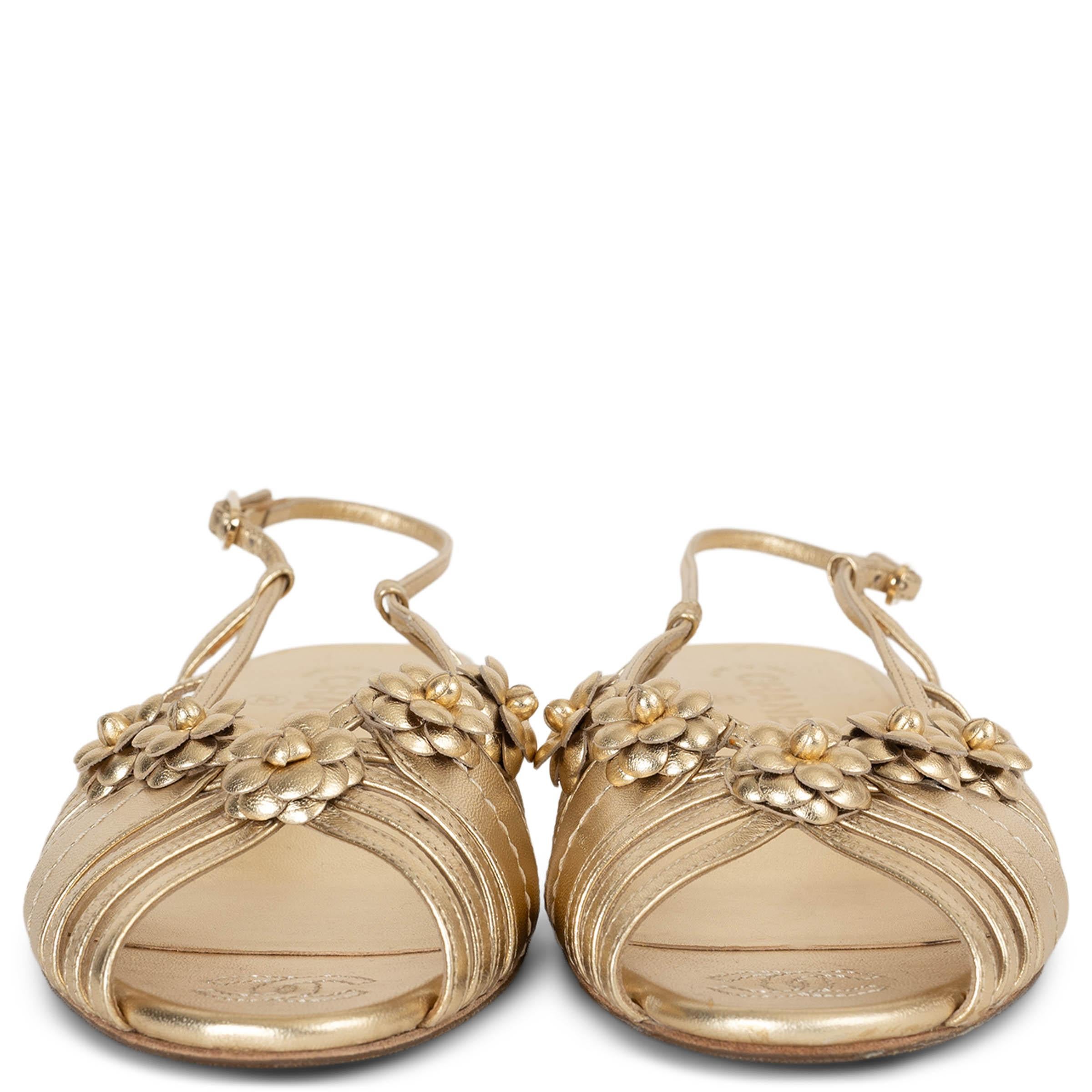 This 100% authentic Chanel slingback sandals in metallic gold laminated lambskin leather exude timeless elegance. Designed with delicate, Camellia-embellished thin straps, they feature peep-toes and a comfortable low block heel. A perfect blend of