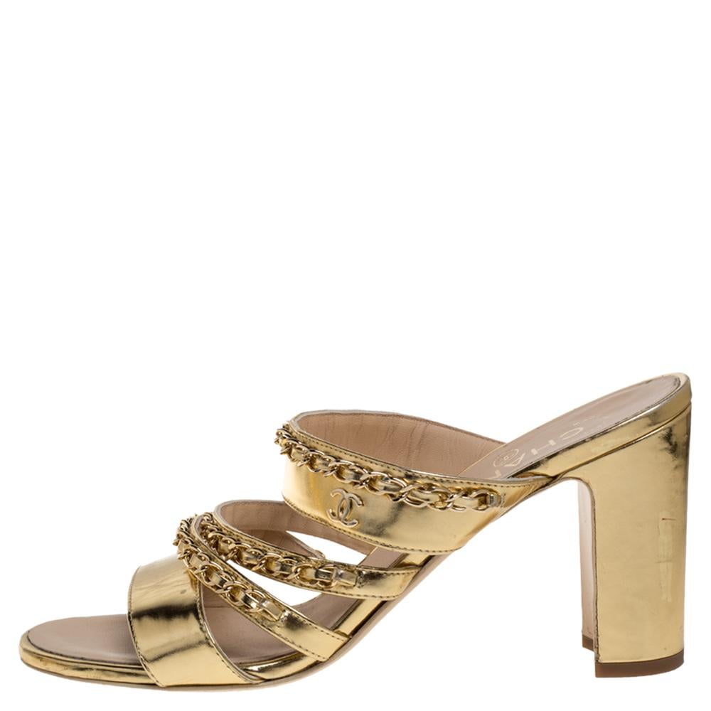 Bring in the subtle glamour to your outfits with this pair of sandals from Chanel. They have been crafted from gold leather and styled with multiple straps at the front accented with interwoven chain details. These sandals come with block heels.