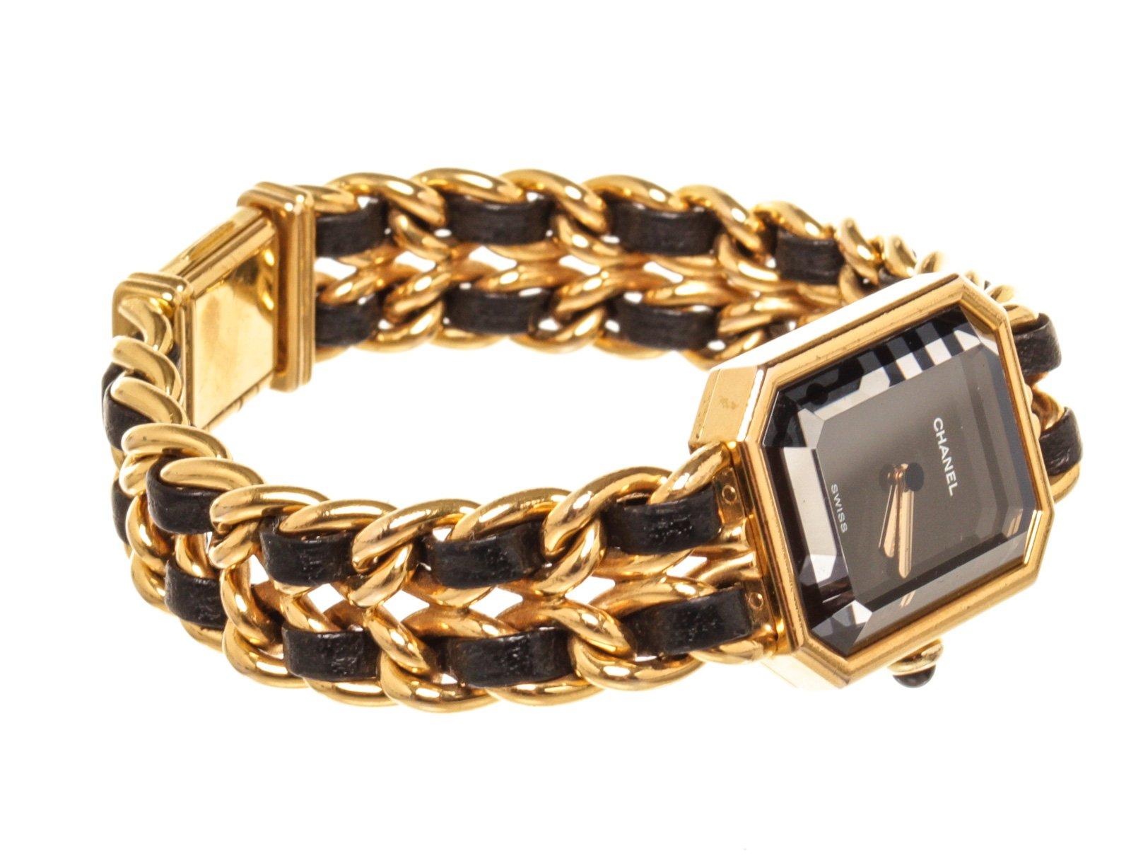 Chanel Gold Leather Premiere L Watch with leather, yellow gold-plated and black leather bracelet; hinged clasp closure.

42135MSC