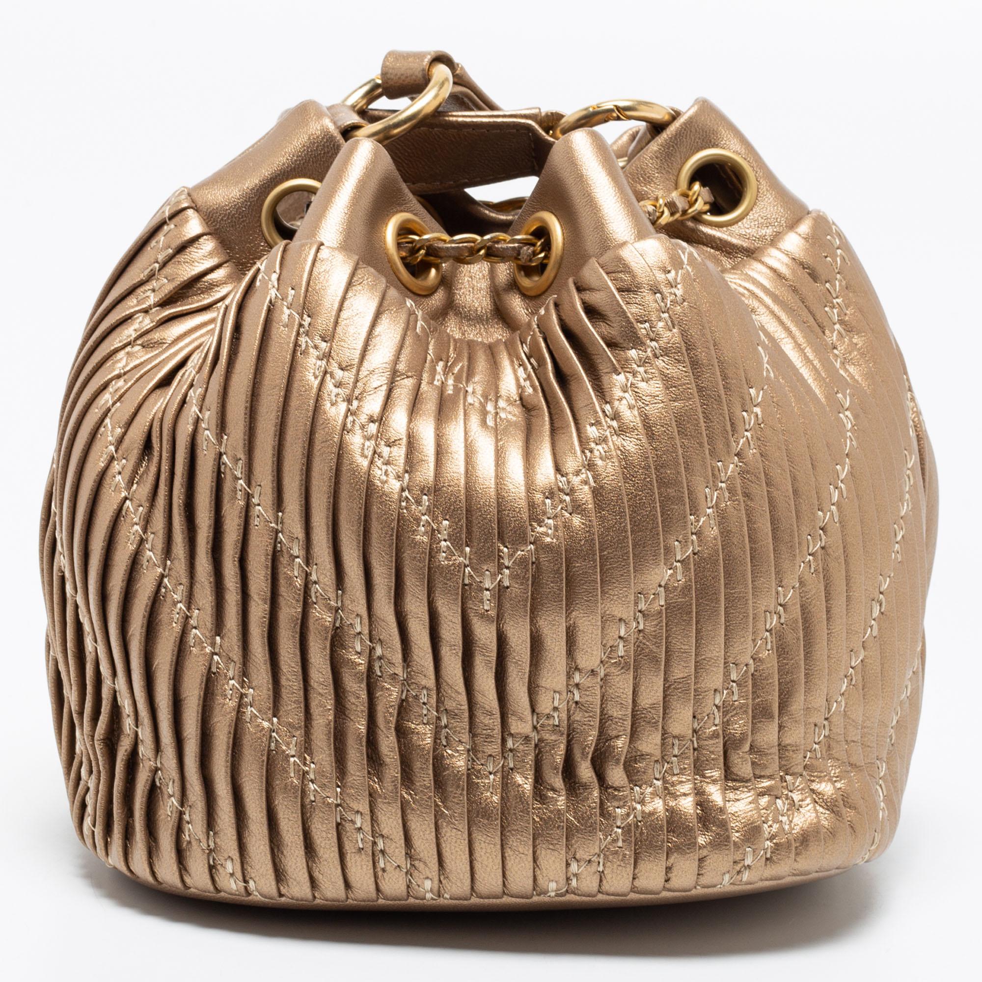 You will enjoy parading this mesmerizing bucket bag from Chanel. It comes made from pleated leather and features a long shoulder strap. The gold-hued beauty is equipped with a fabric interior meant to hold all your party essentials with
