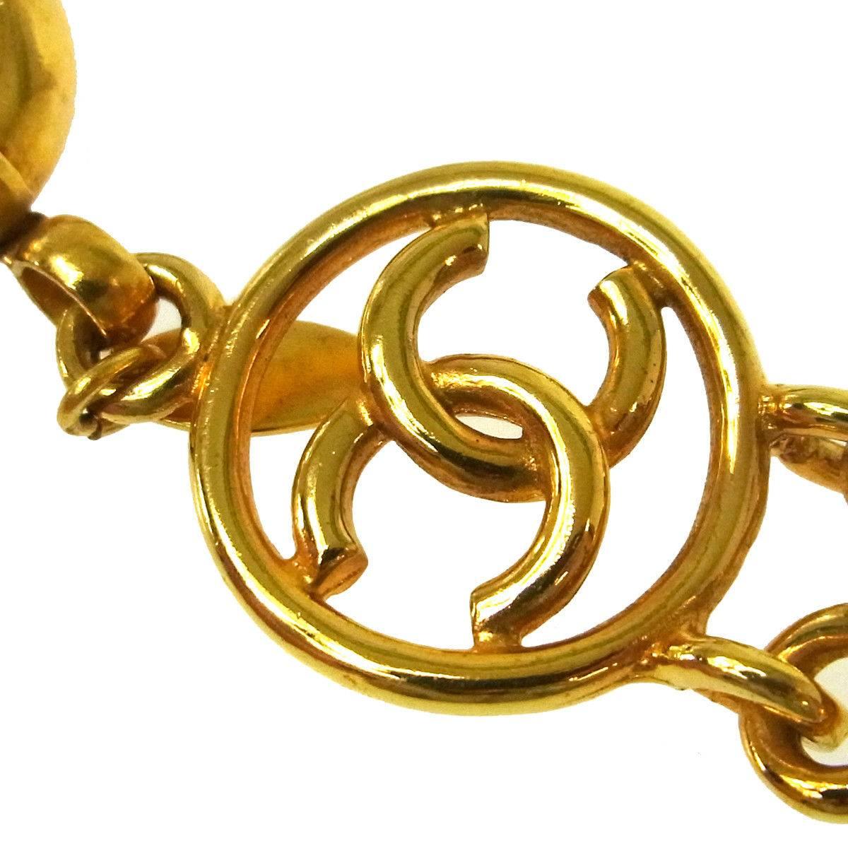 Chanel Gold Logo Charm Braided Twist Statement Evening Bracelet 

Metal
Gold tone hardware
Lobster claw closure 
Charm 1