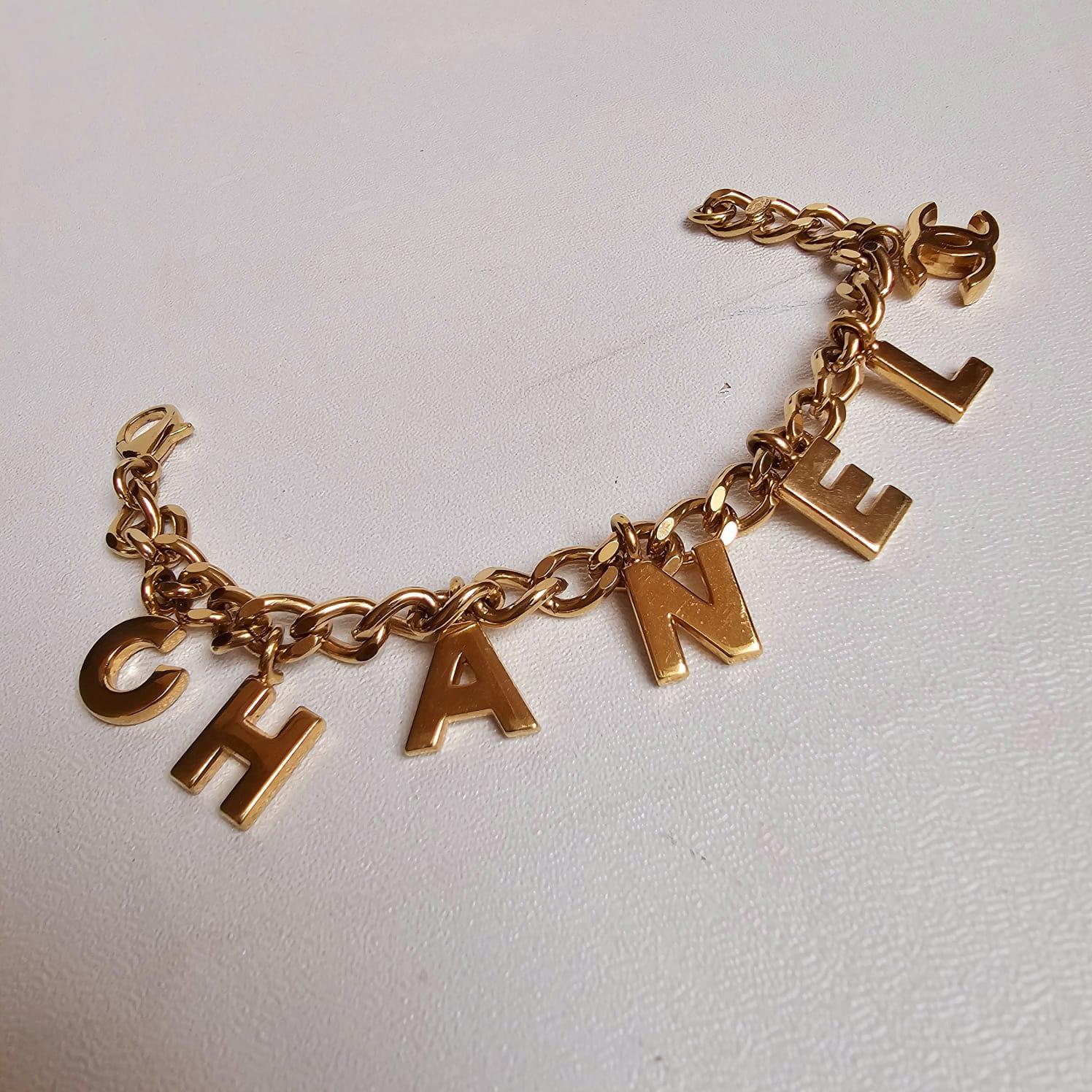 Chanel Bracelet à breloques logo en or en vente 5