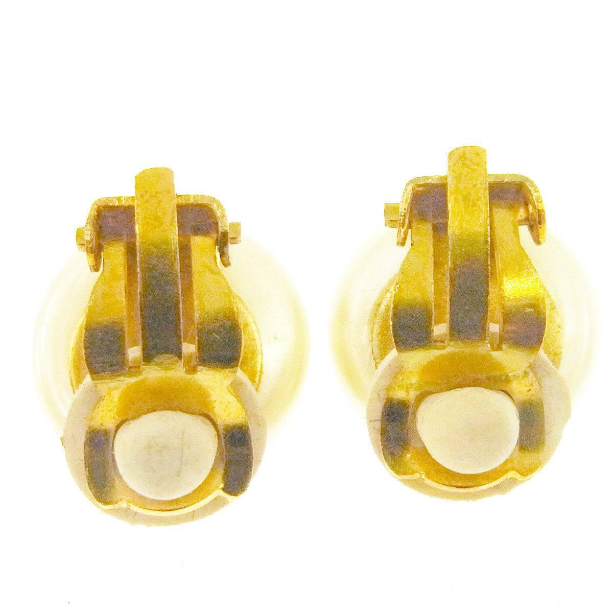 Chanel Gold Logo Charm Evening Pearl Stud Earrings in Box

Faux pearl
Metal
Clip on closure 
Made in France
Diameter 0.30