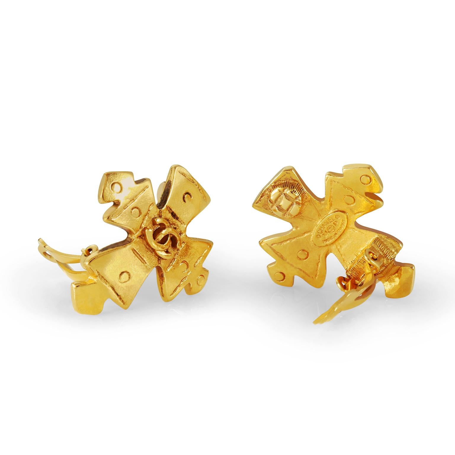 These authentic Chanel Gold Maltese Cross Earrings are in excellent condition from the Spring 1994 collection.  Gold tone Maltese style cross has an interlocking CC in the center.  Clip on style.  Made in France.  Pouch or box included.
