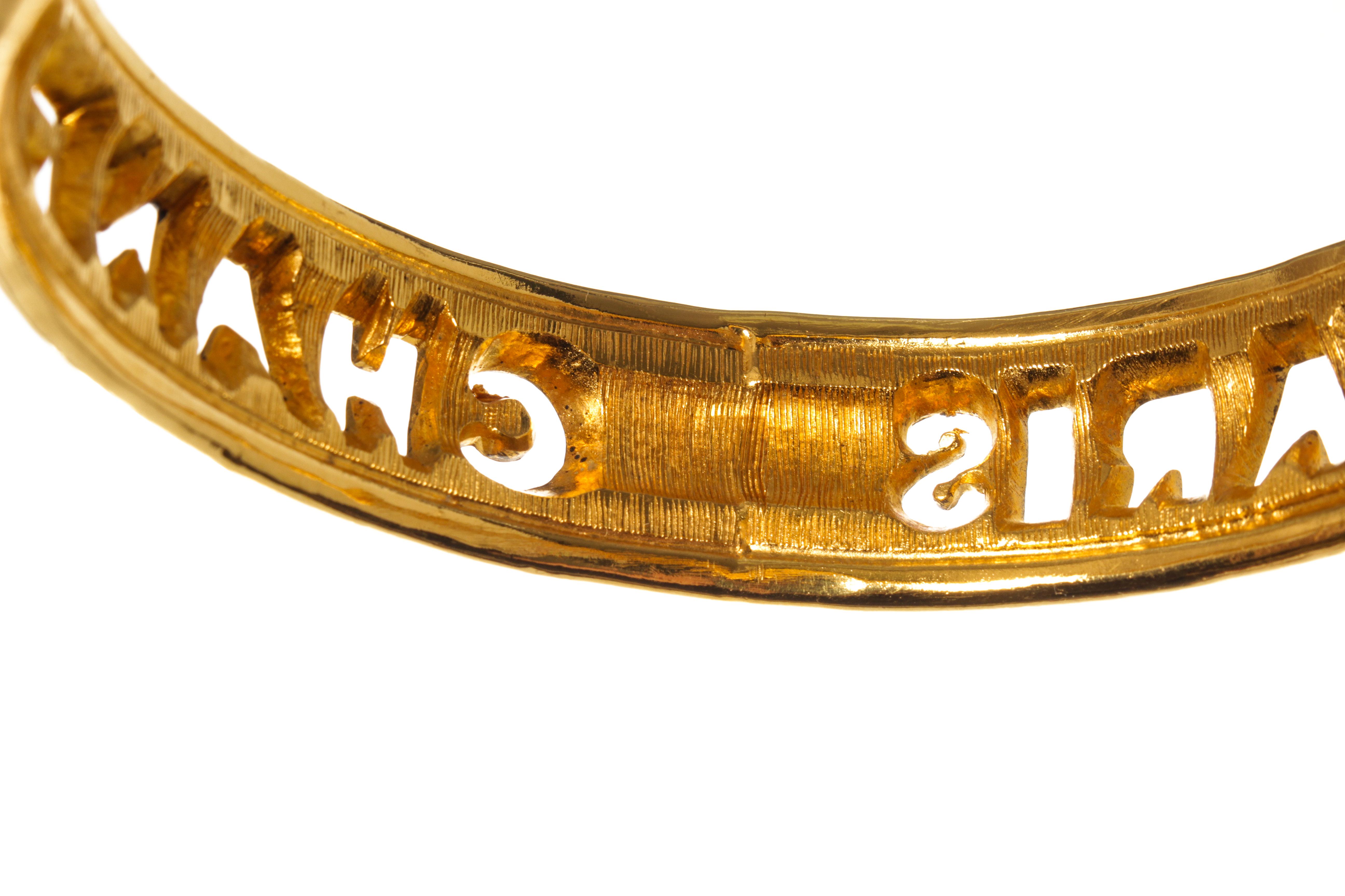 Modern Chanel Gold Metal Cut Out Logo Bangle Bracelet For Sale