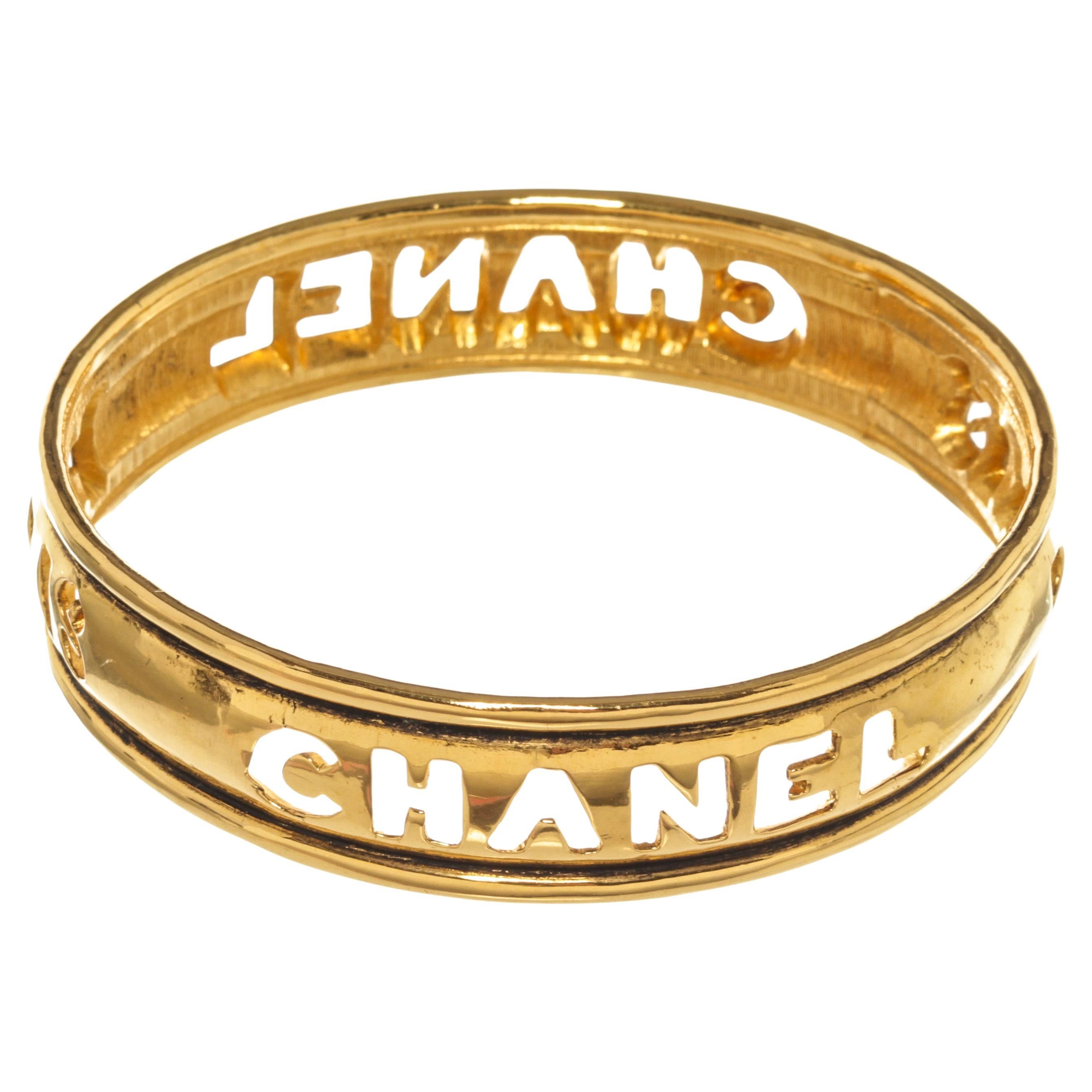 Chanel Gold Metal Cut Out Logo Bangle Bracelet For Sale