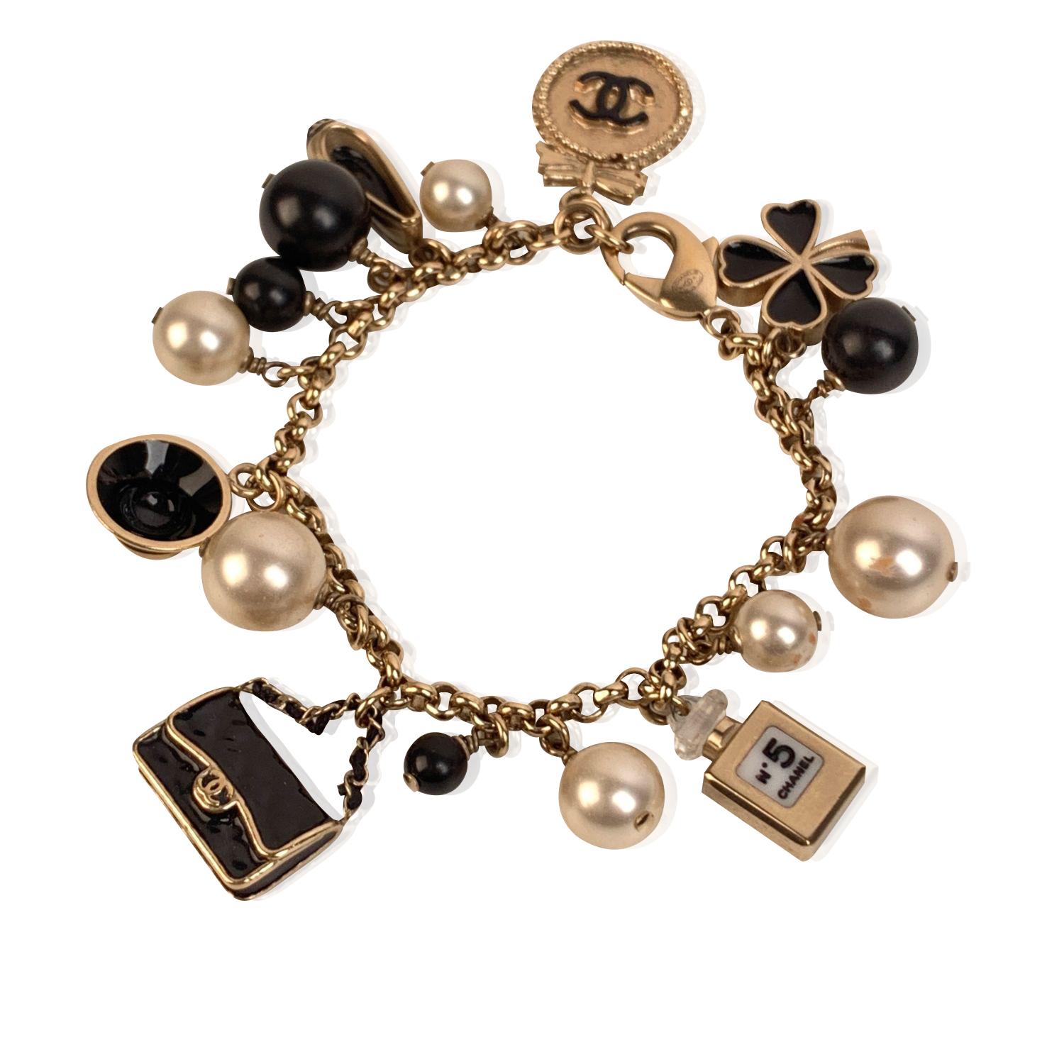 Chanel Gold Metal Faux Pearl and Iconic Charm Bracelet In Excellent Condition In Rome, Rome