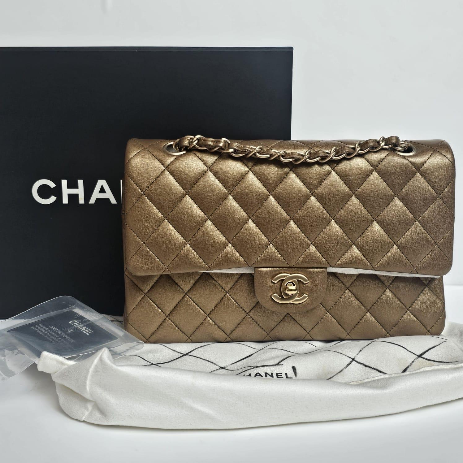 Medium classic bag in gold lambskin with gold hardware. Beautiful collectible classic flap, suitable for formal occasions. Slightly dark gold, slightly bronze like without light exposure. Minor scuffing and scratches on the corners and underflap.