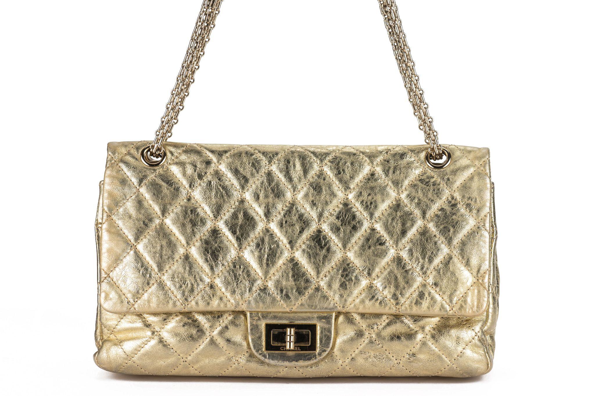 This Chanel limited edition maxi reissue double flap with gold metallic distressed leather, features a thick metal chain strap for elegant wear and a front flap with a ruthenium mademoiselle turn lock. Shoulder drop 10
