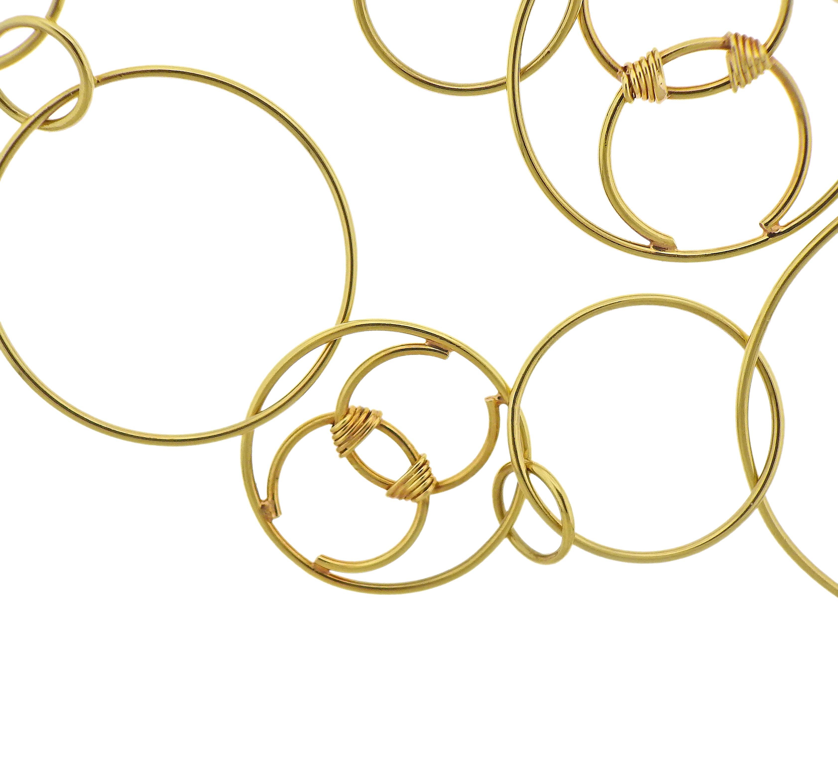 Long 18k yellow gold multi circle link necklace by Chane, with CC elements. Necklace is 36