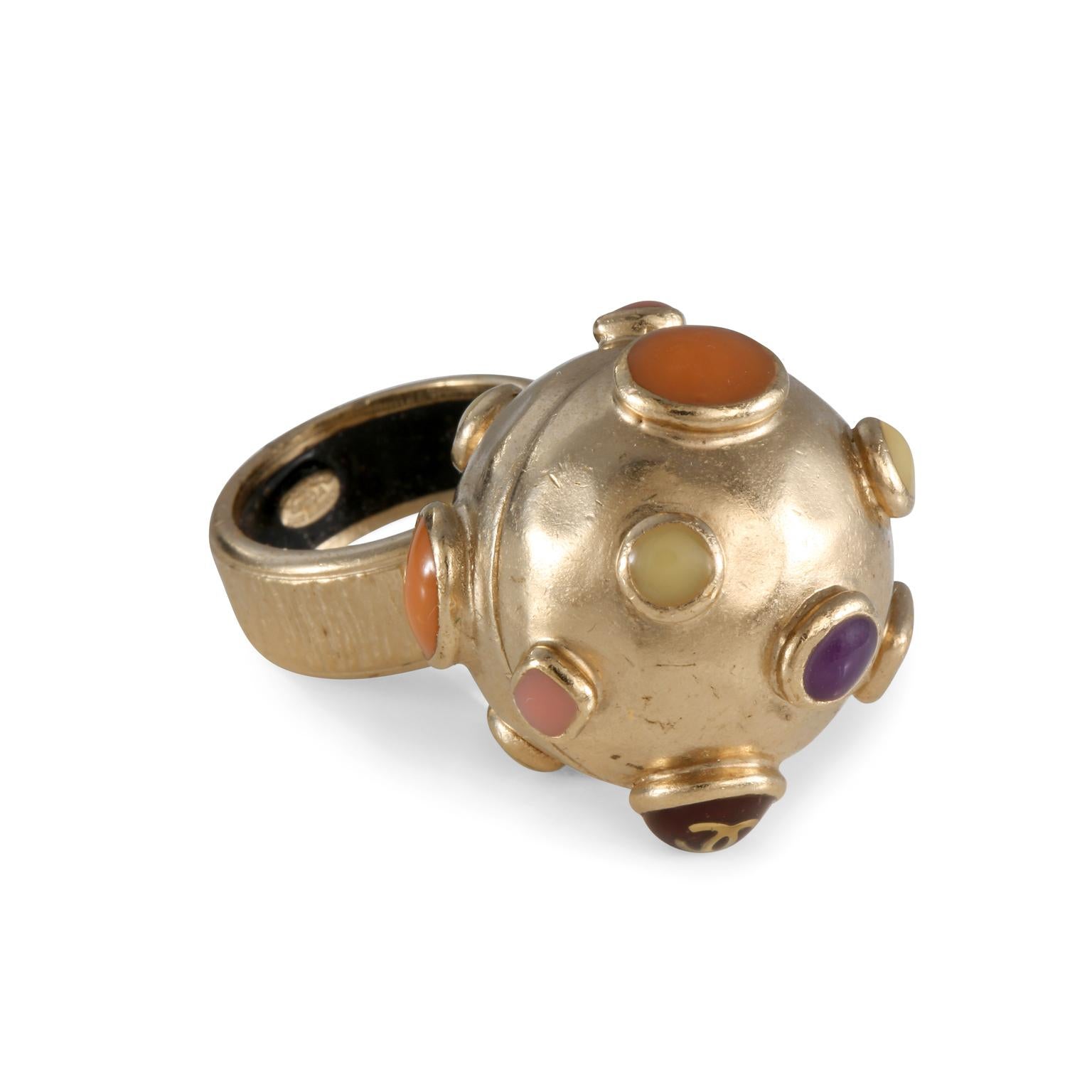 This authentic Chanel Gold Orb Ring is in excellent condition.  Gold tone spherical ring with raised multicolored spots.  Size 6.5.   Pouch or box included. 
