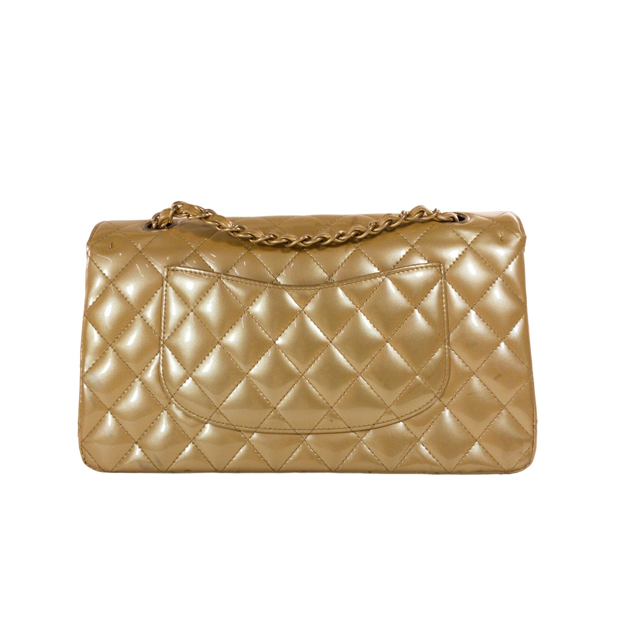 Chanel Gold Patent Medium Flap GHW Bag

This is an authentic Chanel Medium Classic Flap in beige patent leather. The bag has a flap closure with a Double C logo turn lock. The interior is leather and includes one slip pocket and one zip pocket, it