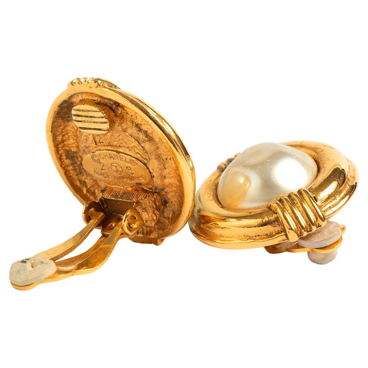 Our vintage Chanel earrings feature a gold metal base and clip with simulated pearl centre. These are early Chanel costume jewellery, stamped 23 2641, dating from season 24 in 1984, designed by Victoire d Castellane under the brand direction of Karl