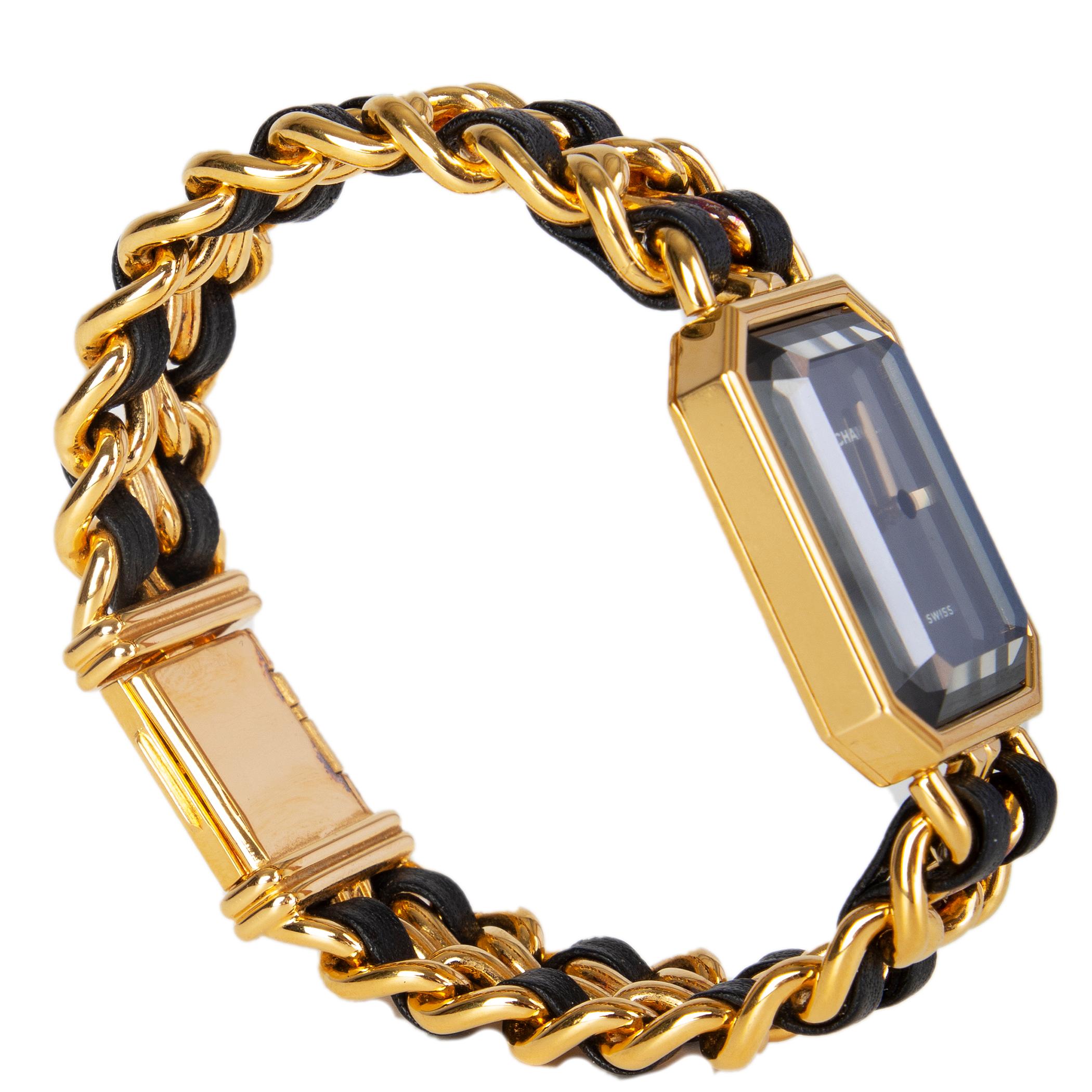 Chanel 'Premiere' watch features a woven gold-tone hardware and black leather chain with quartz movement featuring polished crystal dial features sleek, simple hands and logo lettering at the top. Box clasp at the back. Has been worn with gentle
