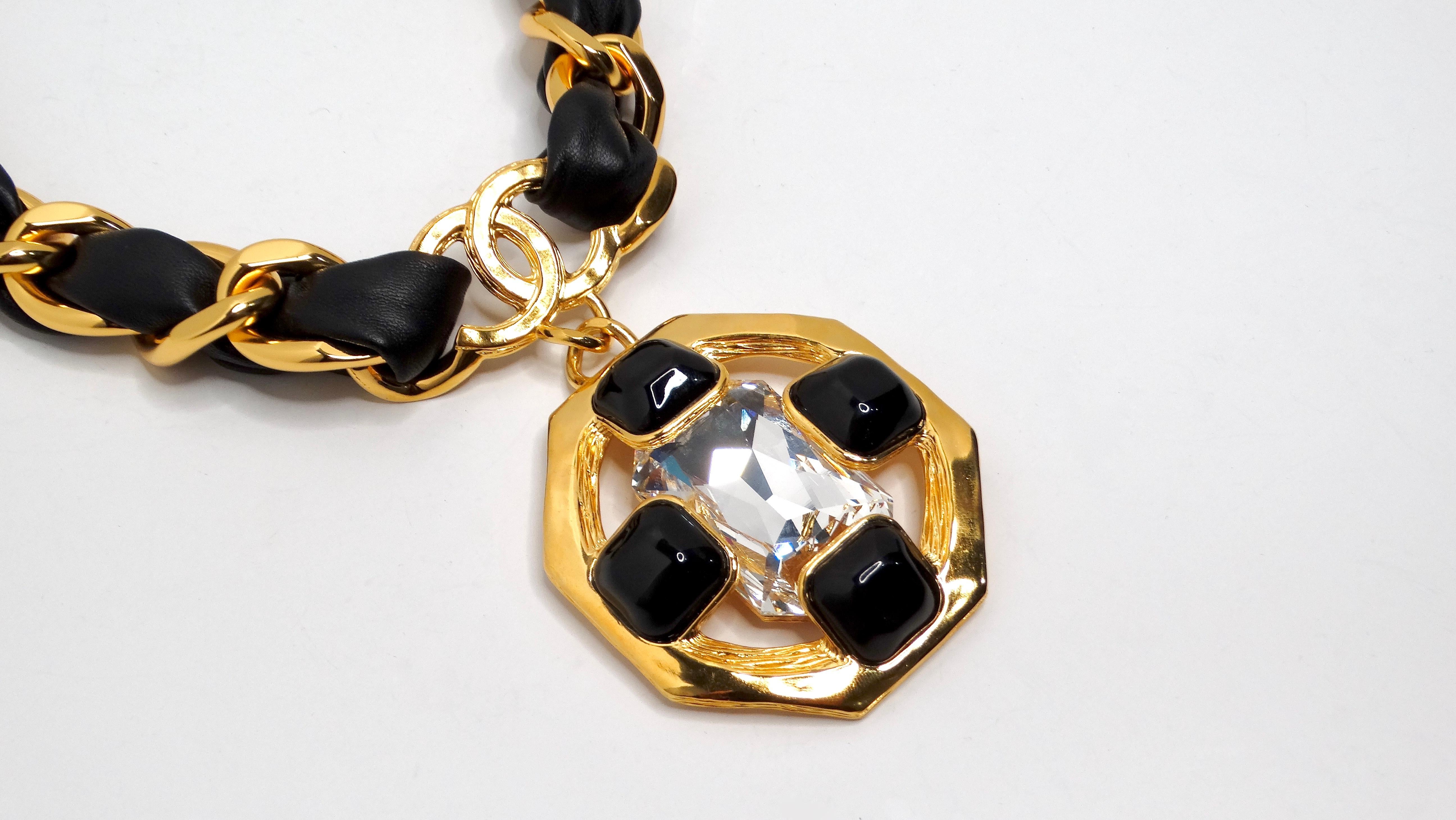 The Chanel Gold Plated CC Gripoix & Crystal Pendant Leather Choker is an exquisite piece that embodies the luxury and sophistication synonymous with the iconic brand. Crafted from classic black leather and featuring a stunning gold-plated chain,