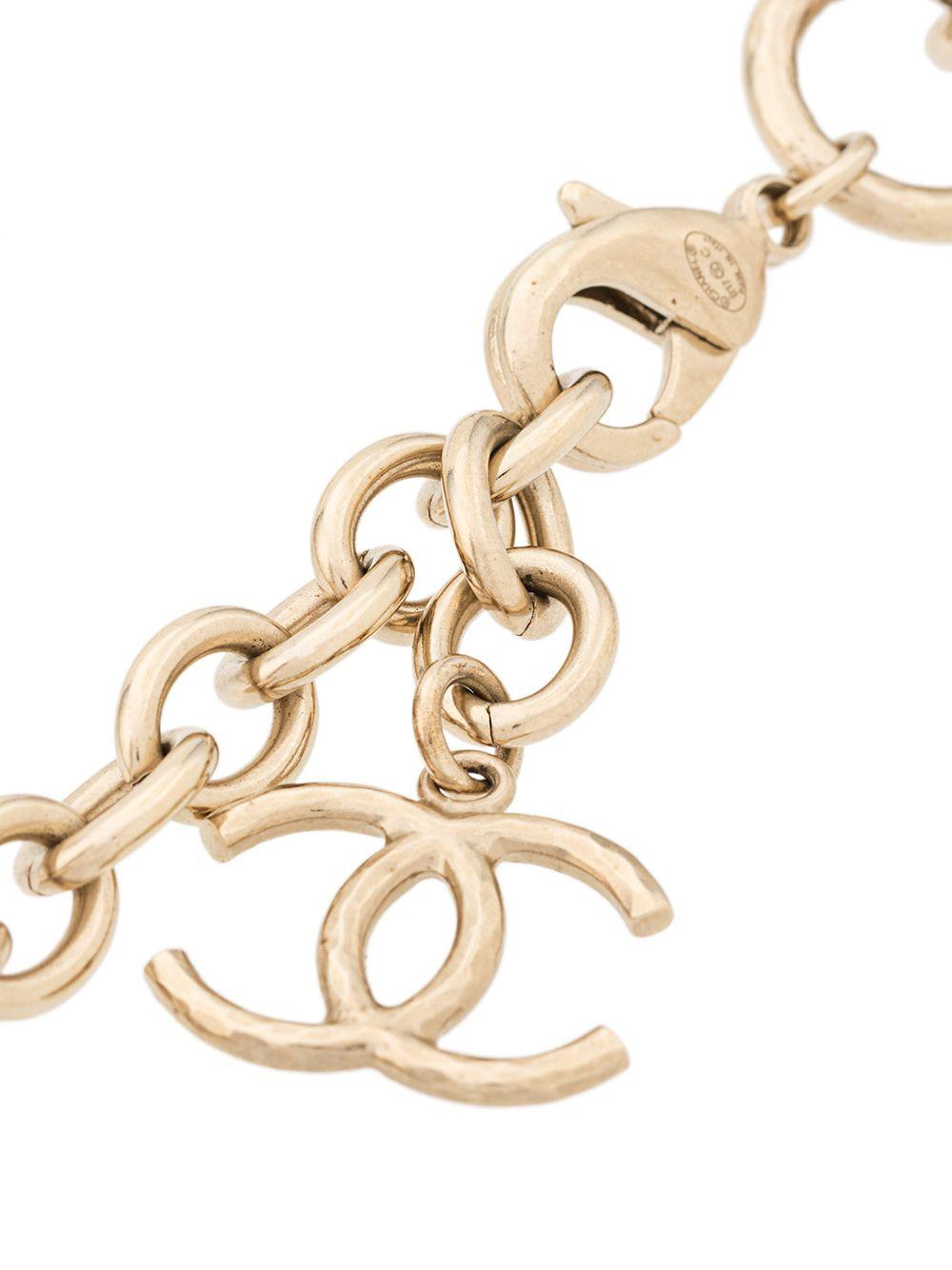 Crafted in France, this elegant, pre-owned necklace from Chanel is a unique piece that adds a touch of classic sophistication to any outfit. With distinctive lettered initial details contained within the gold-plated metal links of the chain spelling