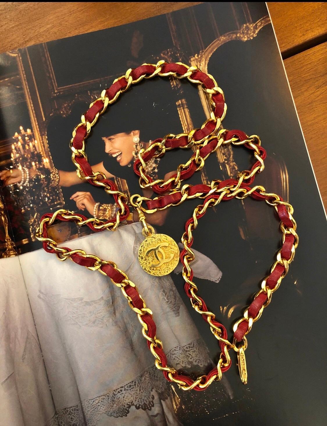 This authentic Chanel leather chain belt is in excellent. Gone toned chain interlaced with red leather featuring a CC coin at one end. Fits waist upto 37 inches. Adjustable hook fastening. It can be worn as a belt or a multi-layered necklace.